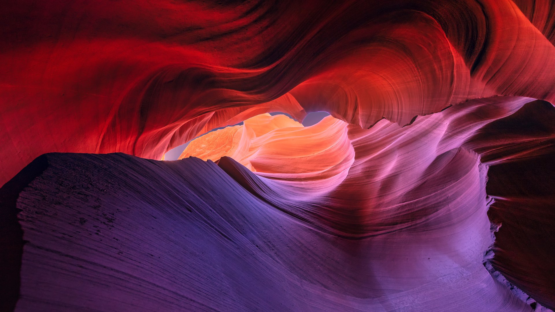 Stunning view of Antelope Canyon's colorful sandstone formations with vibrant red and purple hues.