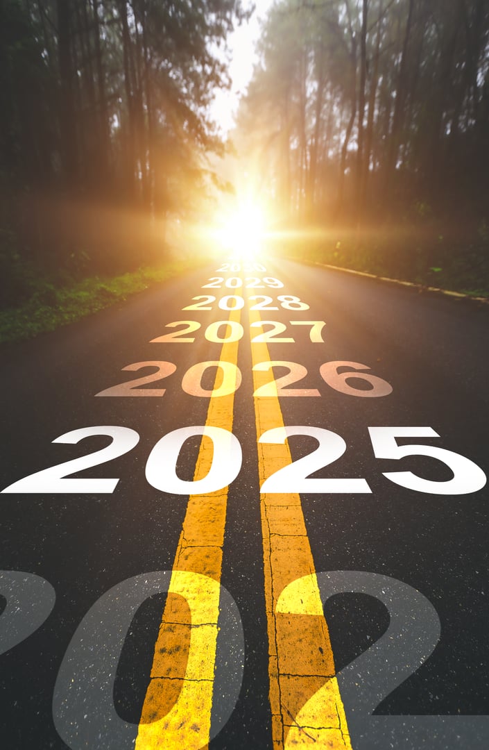 New year 2025 concept. Text 2025 written on the road in the middle of asphalt road with at sunset. Concept of planning, goal, challenge, new year resolution.