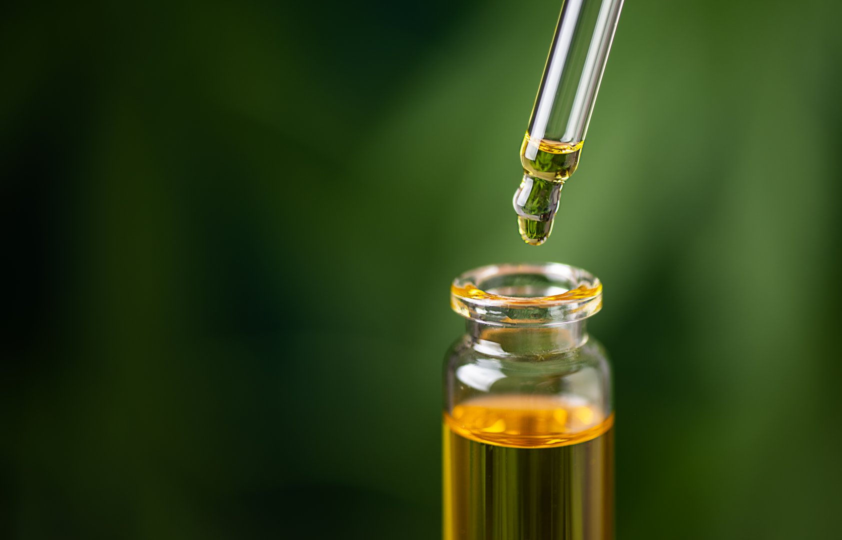 CBD hemp oil on cannabis leaf background. CBD oil extract. Medical cannabis sativa extraction. Biomedical and hemp herbal medicine.
