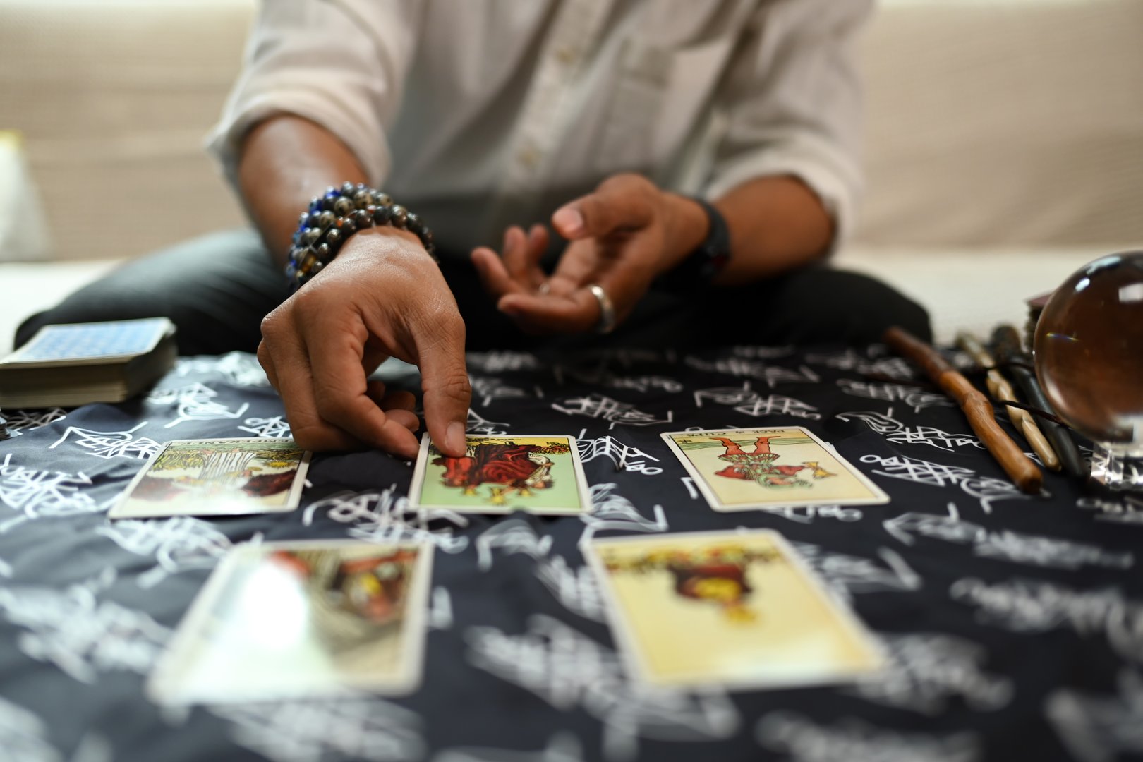 Fortune teller arranging tarot cards on desk. Forecasting and Divination concept.