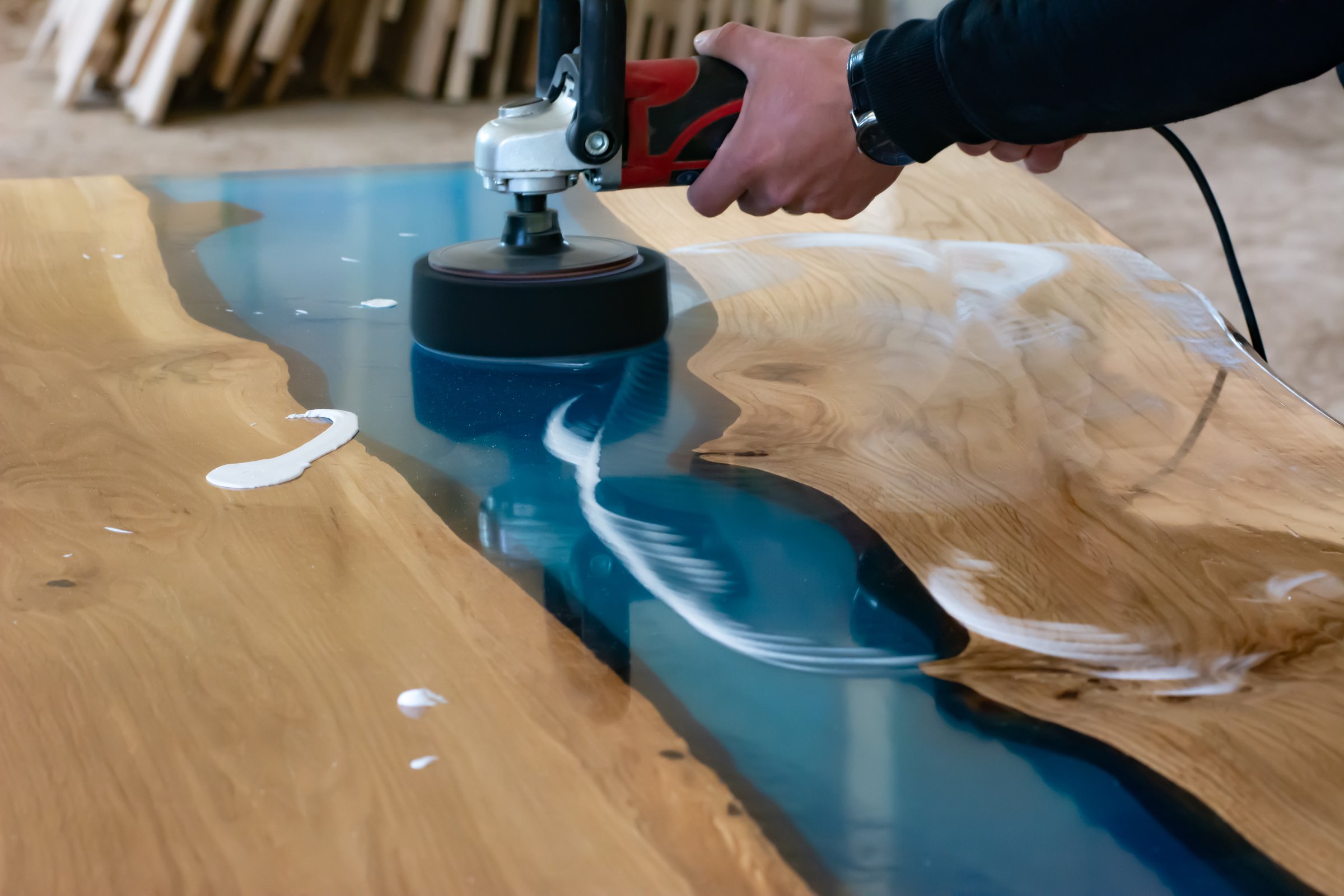 Lacquer polishing on an oak and epoxy resin table in a local workshop