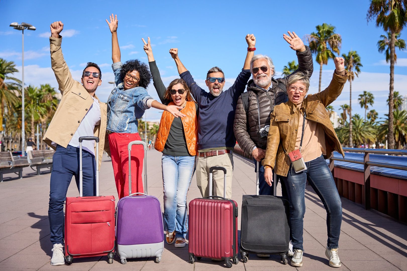 Diverse group celebrating holidays with luggage