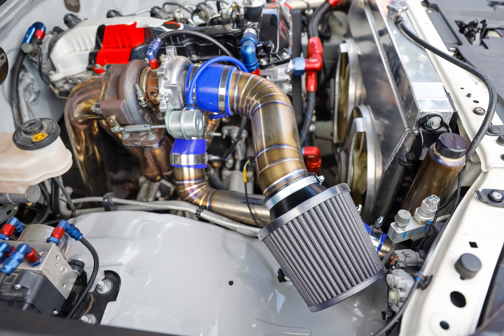 Air filter with turbocharger in racing car engine.