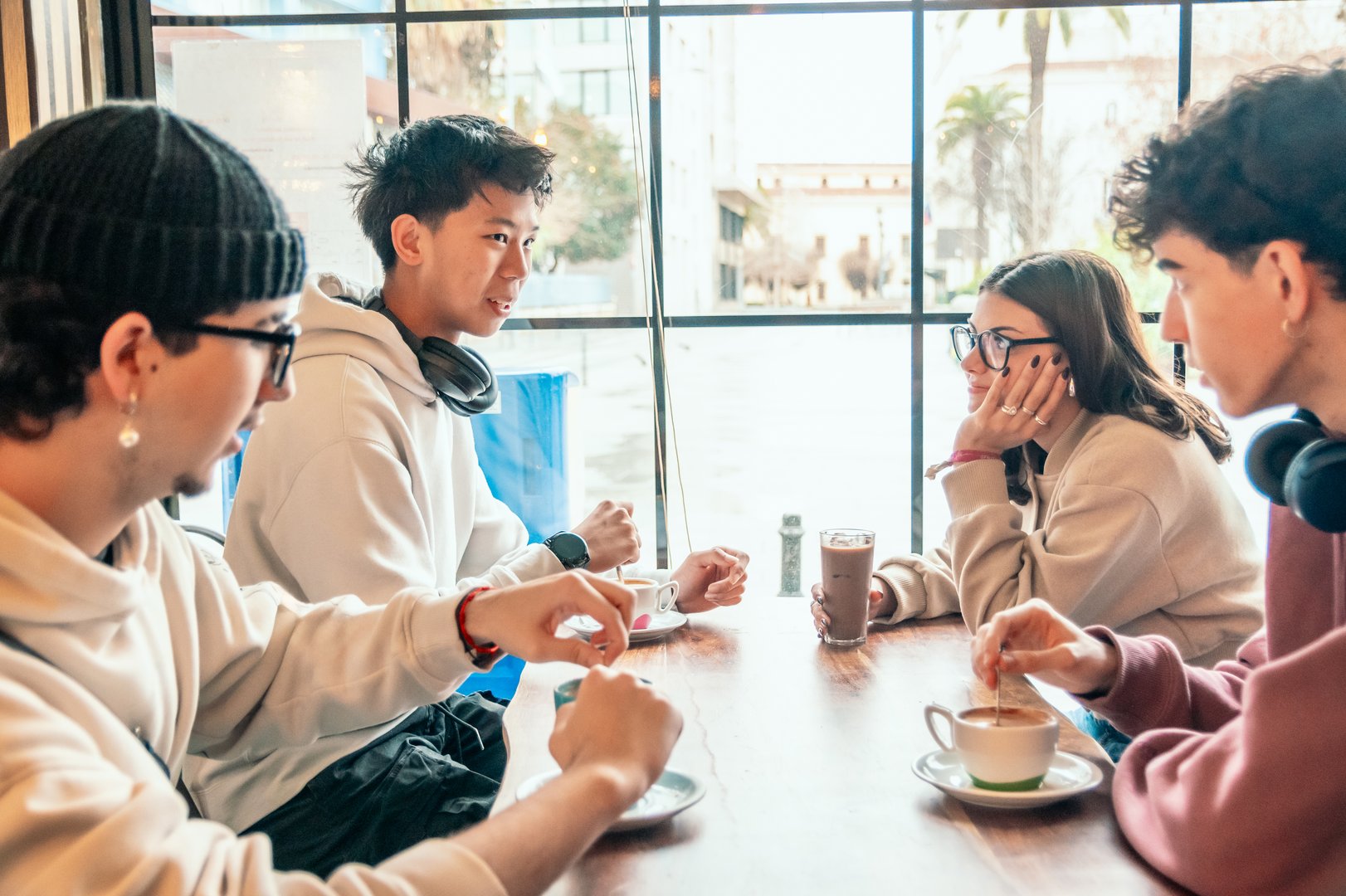 Group of friends enjoying coffee and board games at cafe