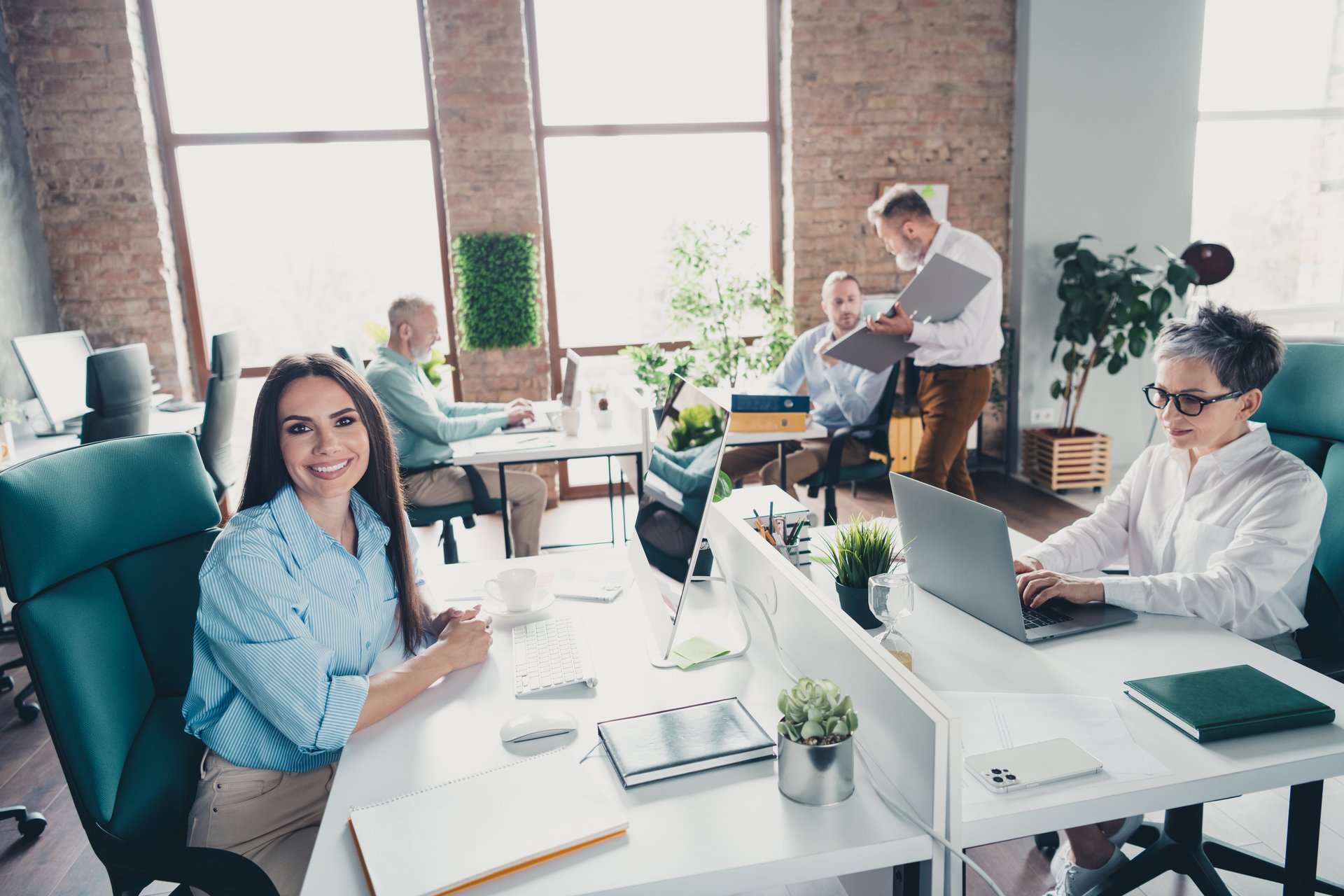 Photo of teamwork people working together comfortable modern office loft room interior indoors workspace.