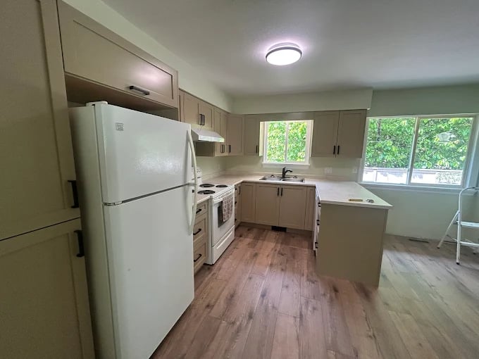 Kitchen renovation with light cabinets and quartz countertops