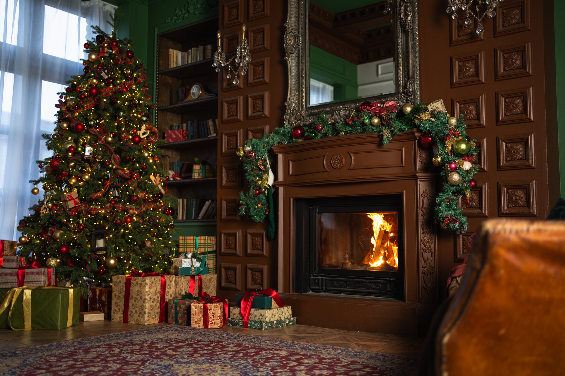 Classical Christmas decorated interior living room with fireplace. Christmas tree with red golden ornament decorations gift boxes. Modern classic style interior design apartment. Christmas eve at home