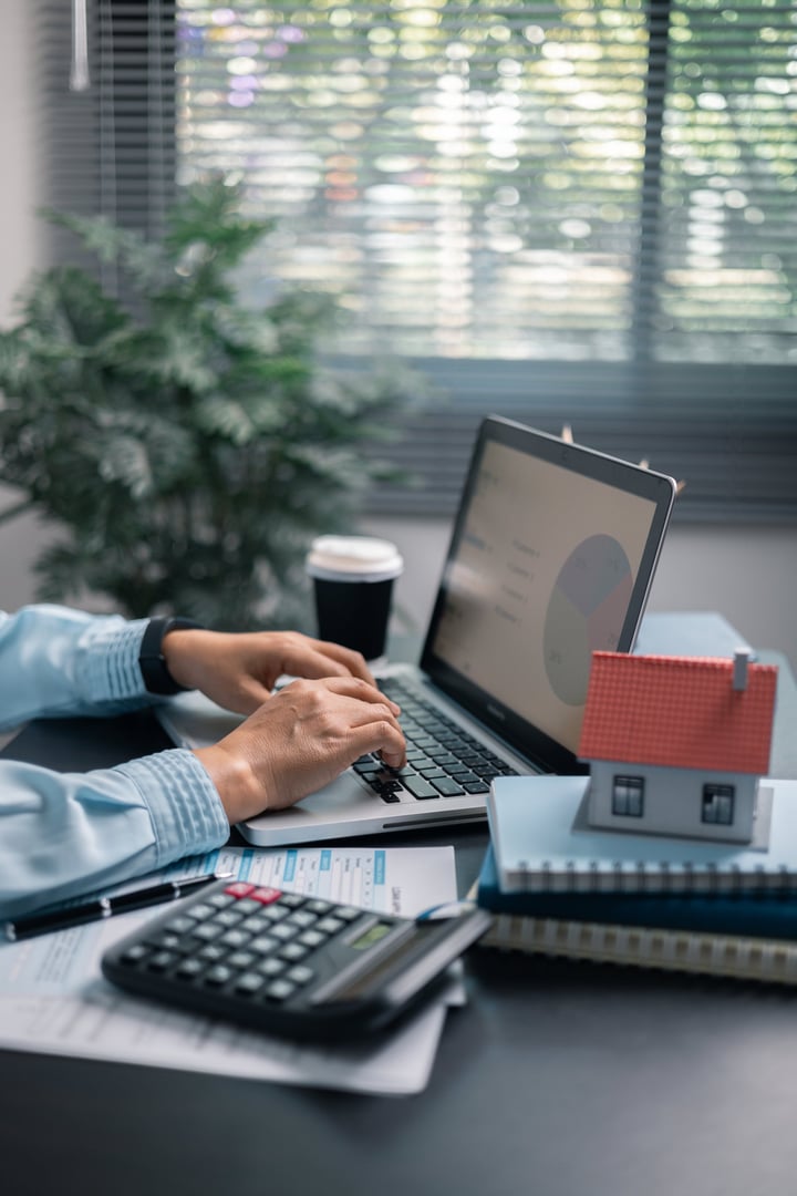 Finance bank tax expense accounting budget money businessman hand use Financial calculate accountant close up calculator with graph chart write office desk Business expense analysis saving home car