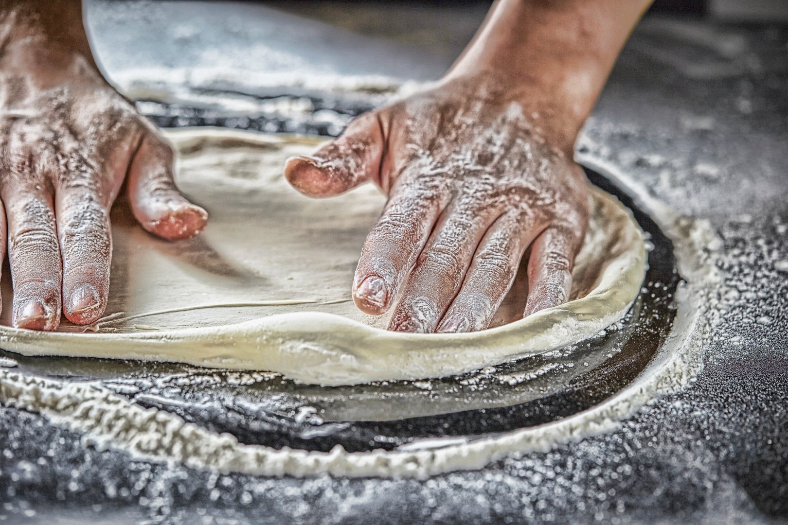 Kneading pizza dough