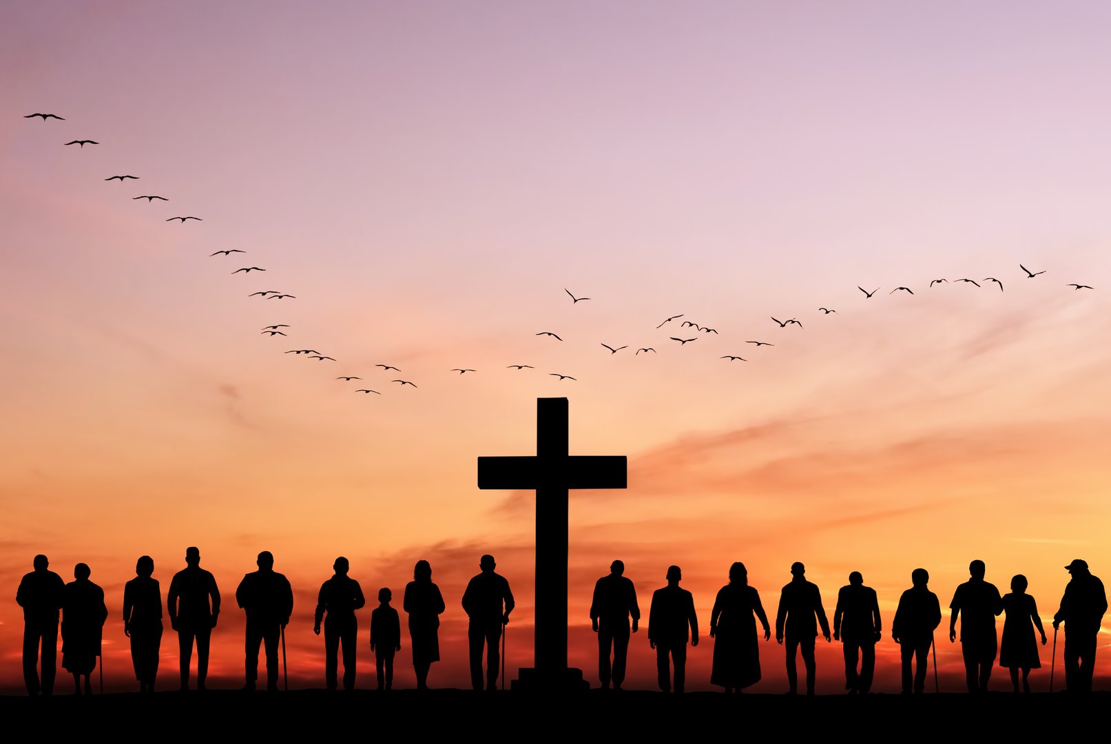 Large group of people stand near cross against backdrop of sunset, resurrection of Easter Sunday concept