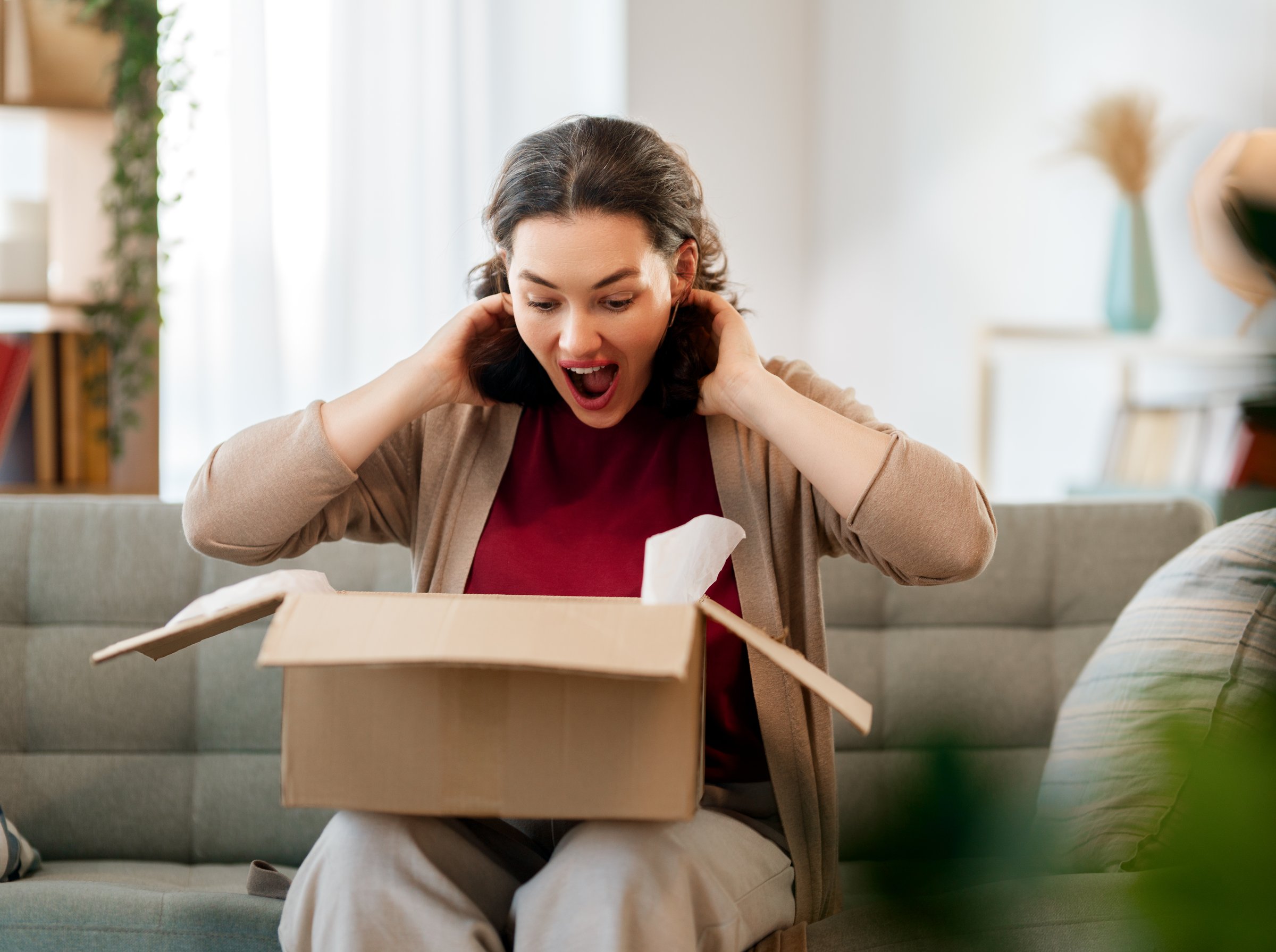 Woman is unpacking cardboard. Concept of online shopping.
