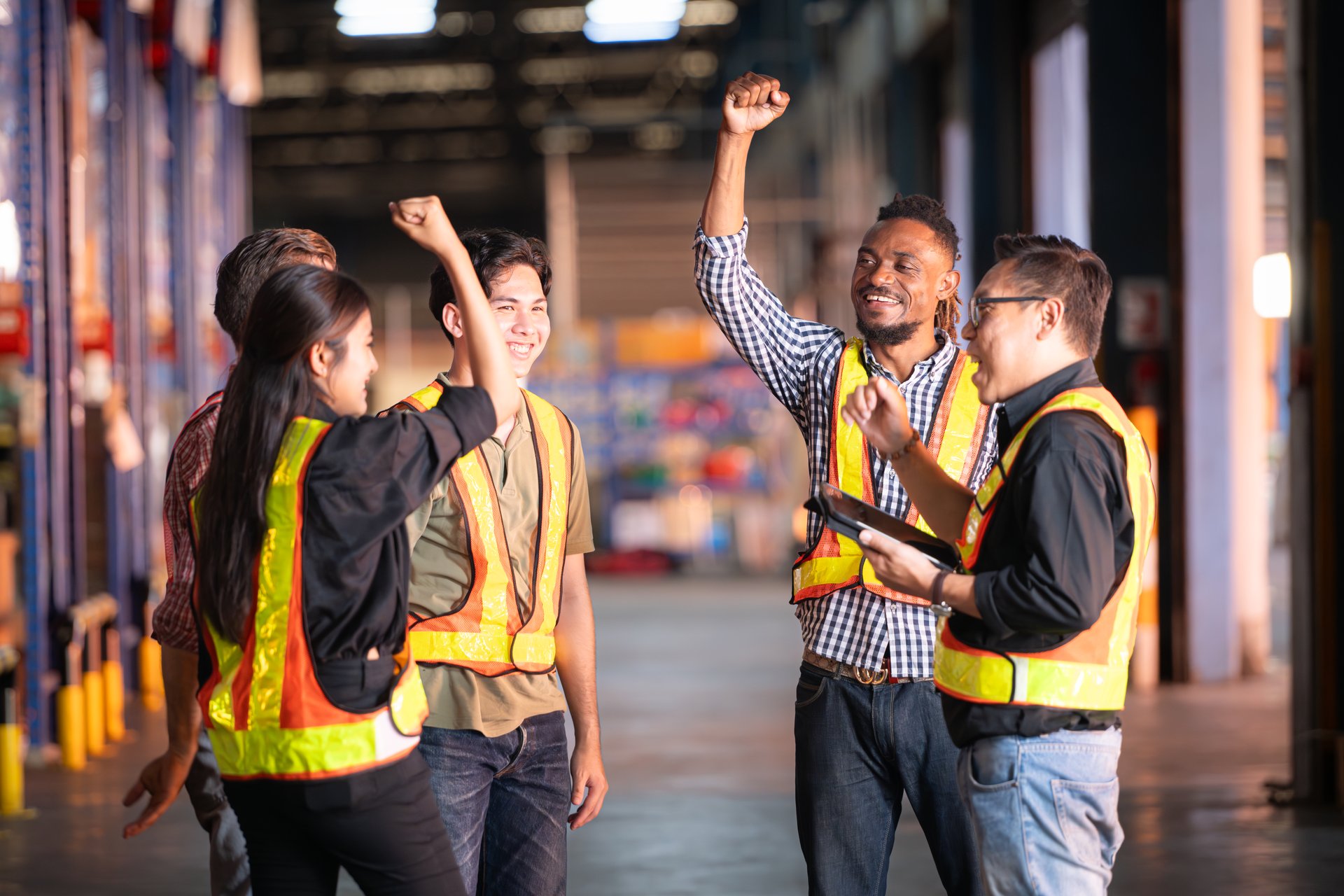 A group of warehouse employees, Inspecting products on warehouse shelves before they are sent to retailer