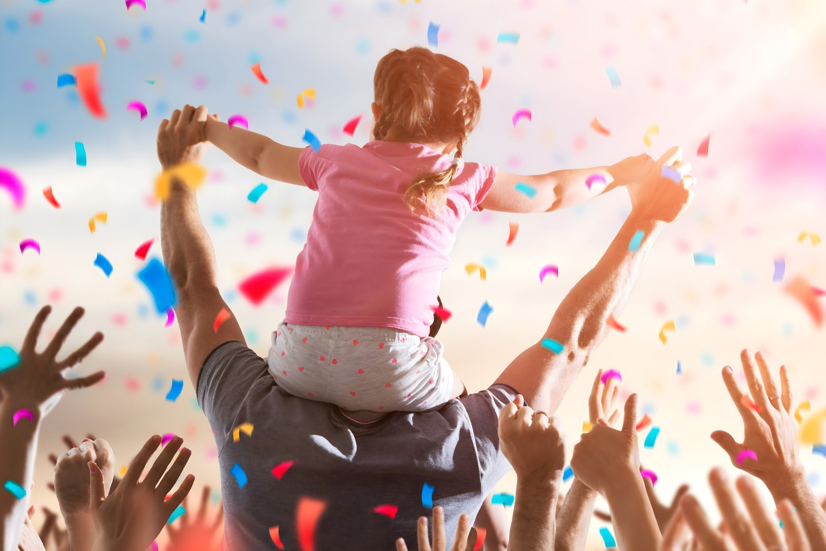 Little Girl On Dads Shoulders At Celebration Event