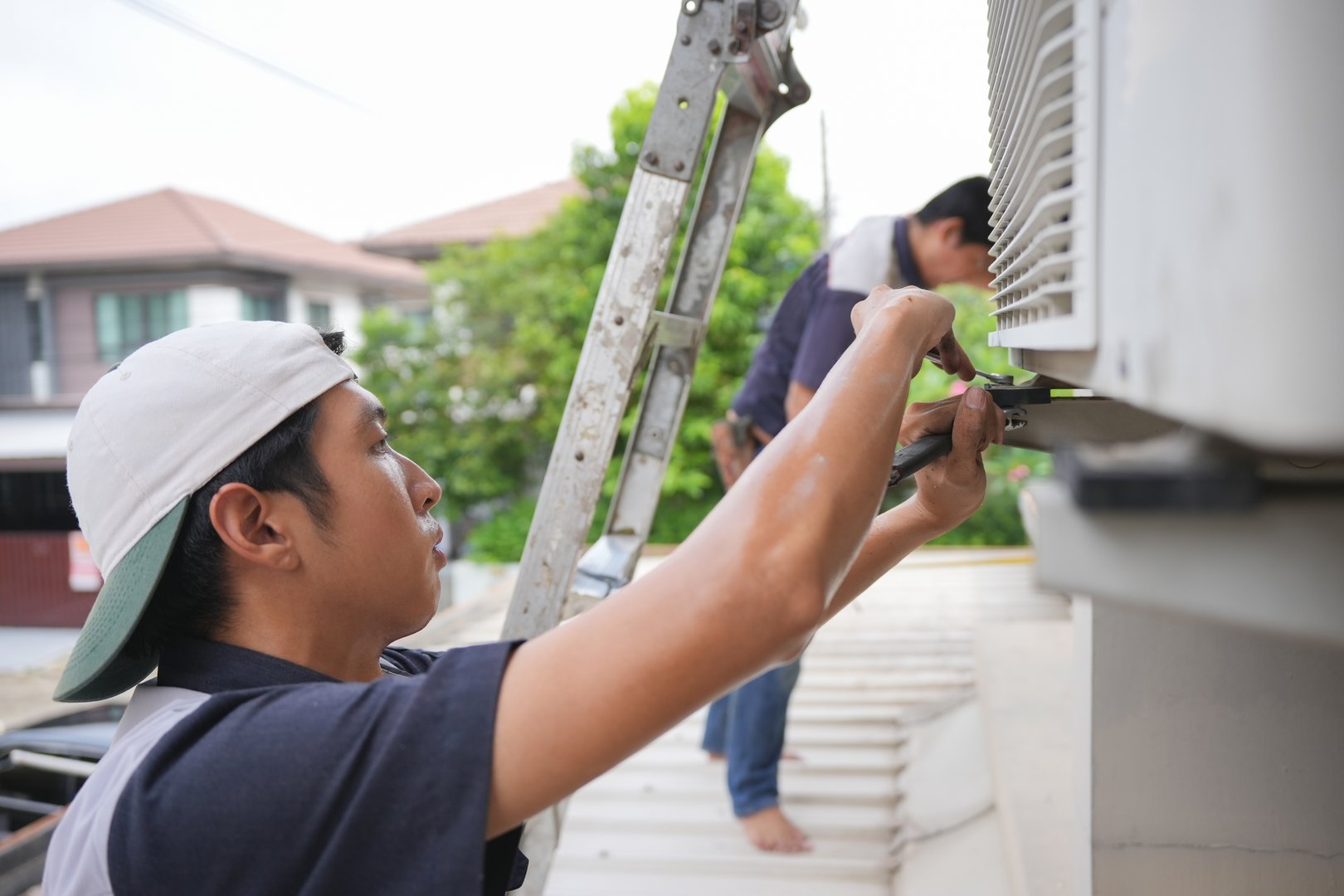 Air conditioning technician team install new air conditioners in homes, Repairman fix air conditioning systems, Male technician service for repair and maintenance of air conditioners