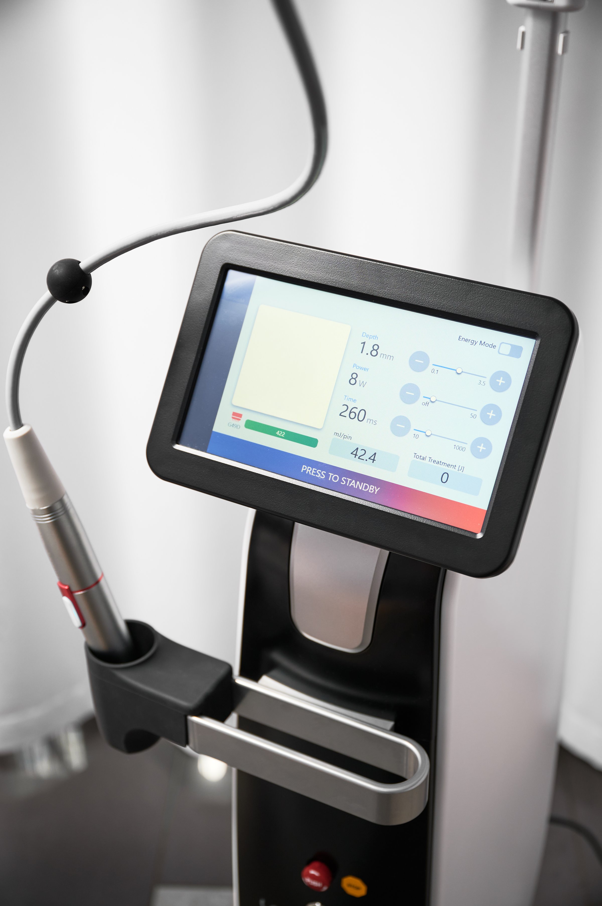 Modern cosmetology equipment for skincare rejuvenation treatment with patient on monitor display in cosmetology clinic. Radiofrequency microneedling device for collagen induction face lifting therapy.