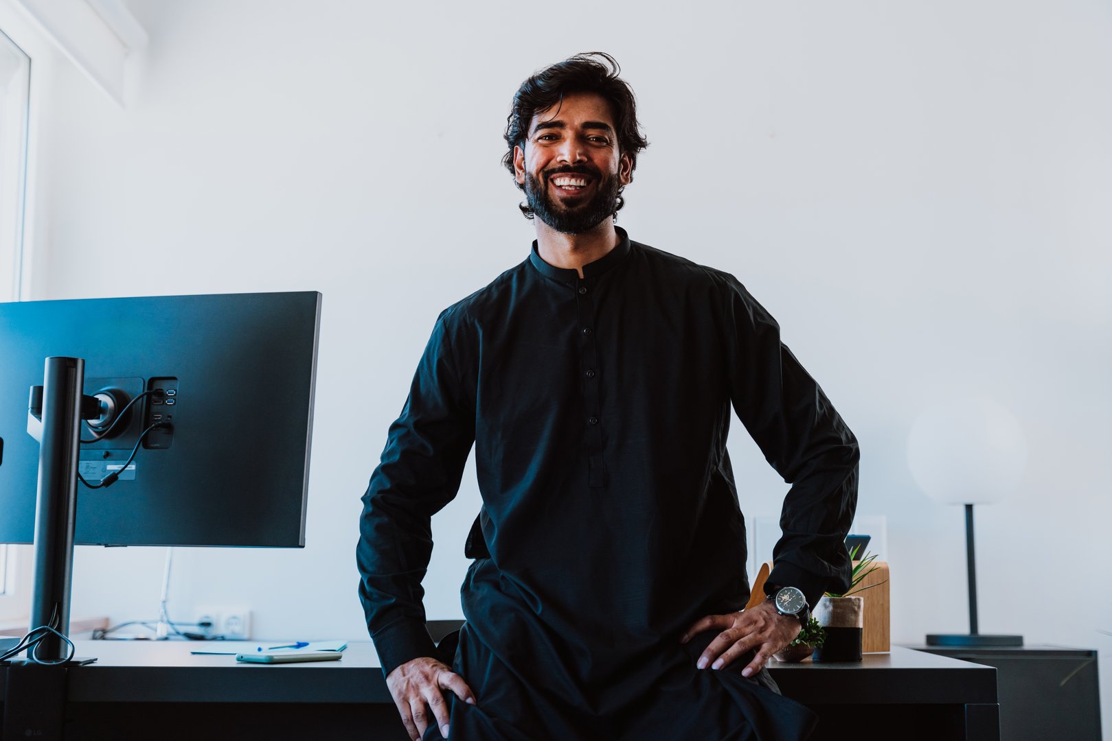 Pakistani Business man in the  office. Young business man with traditional outfit working in his office.