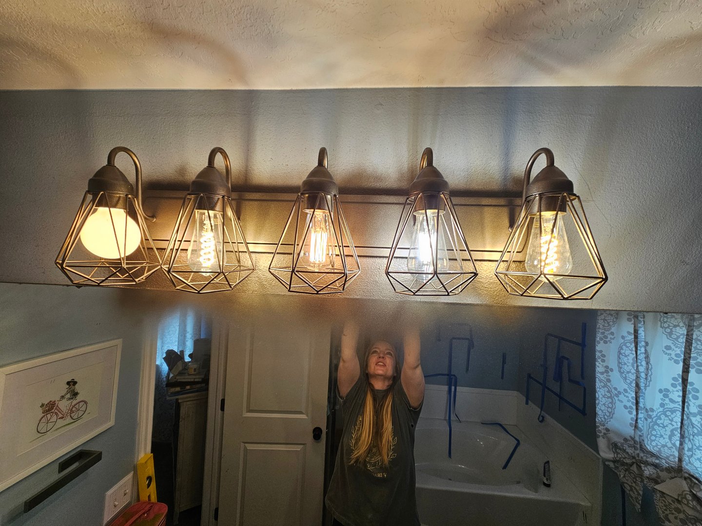 Bathroom light fixture spray painted with Behr Metallic Oil-Rubbed Bronze