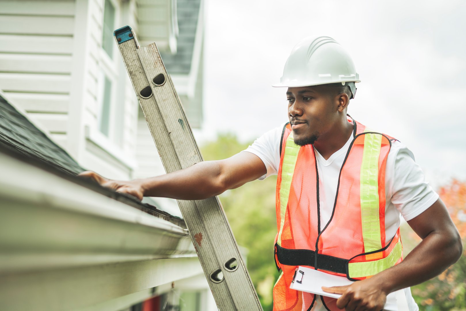 A black man with hard hat to house inspector