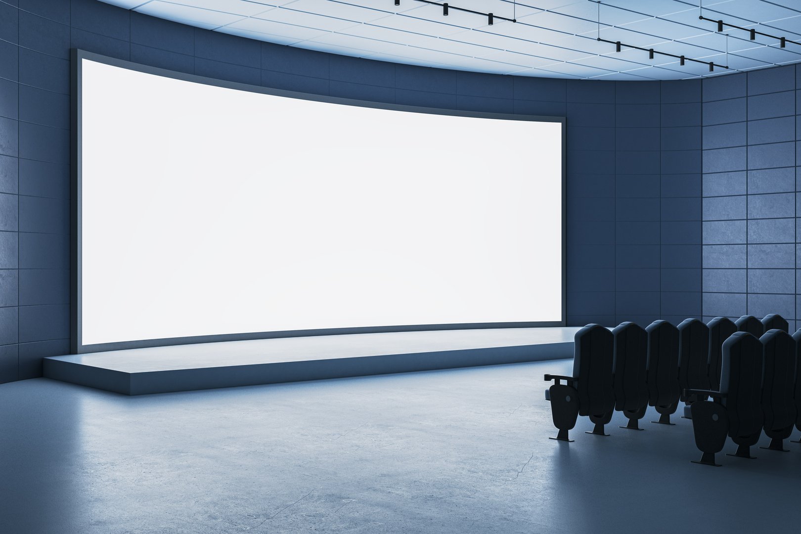 Large blank curved screen on stage in dark modern auditorium with empty chairs, clean interior background for business or digital presentation concept. 3D Rendering