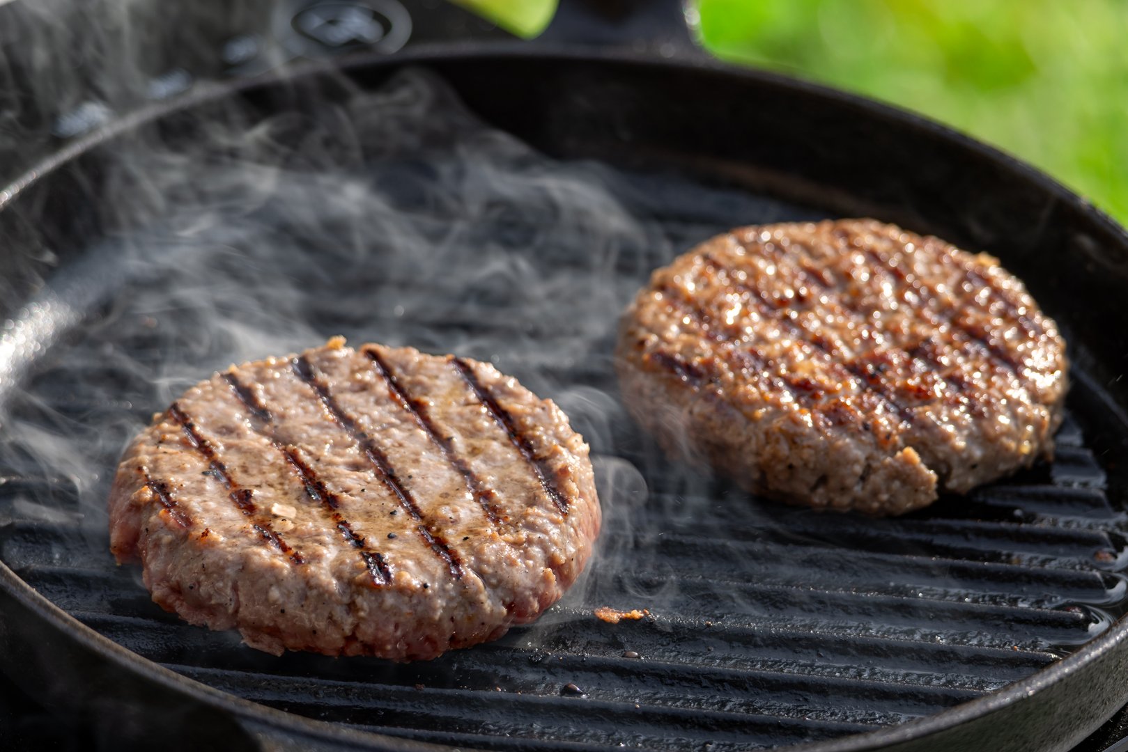 fresh burger meat patty on grill pan