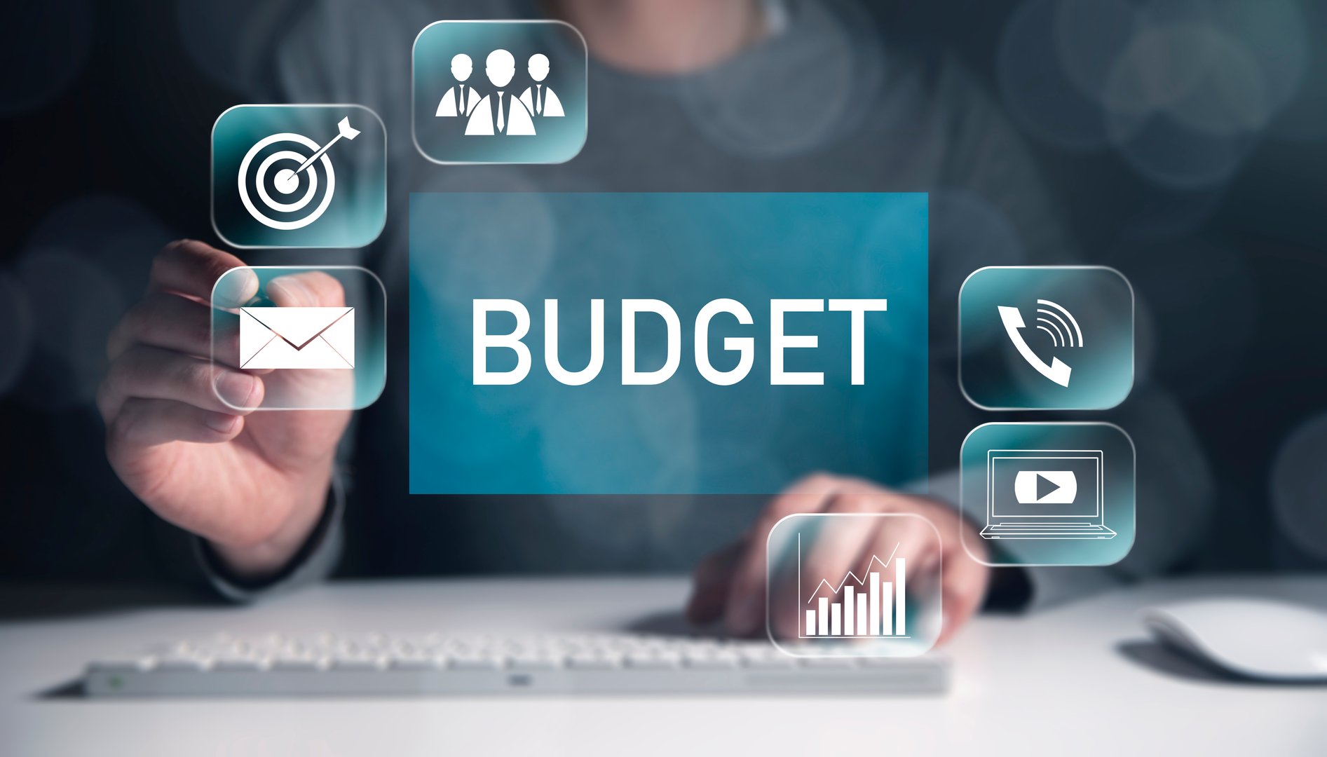 budget text on virtual screen with worker working in computer
