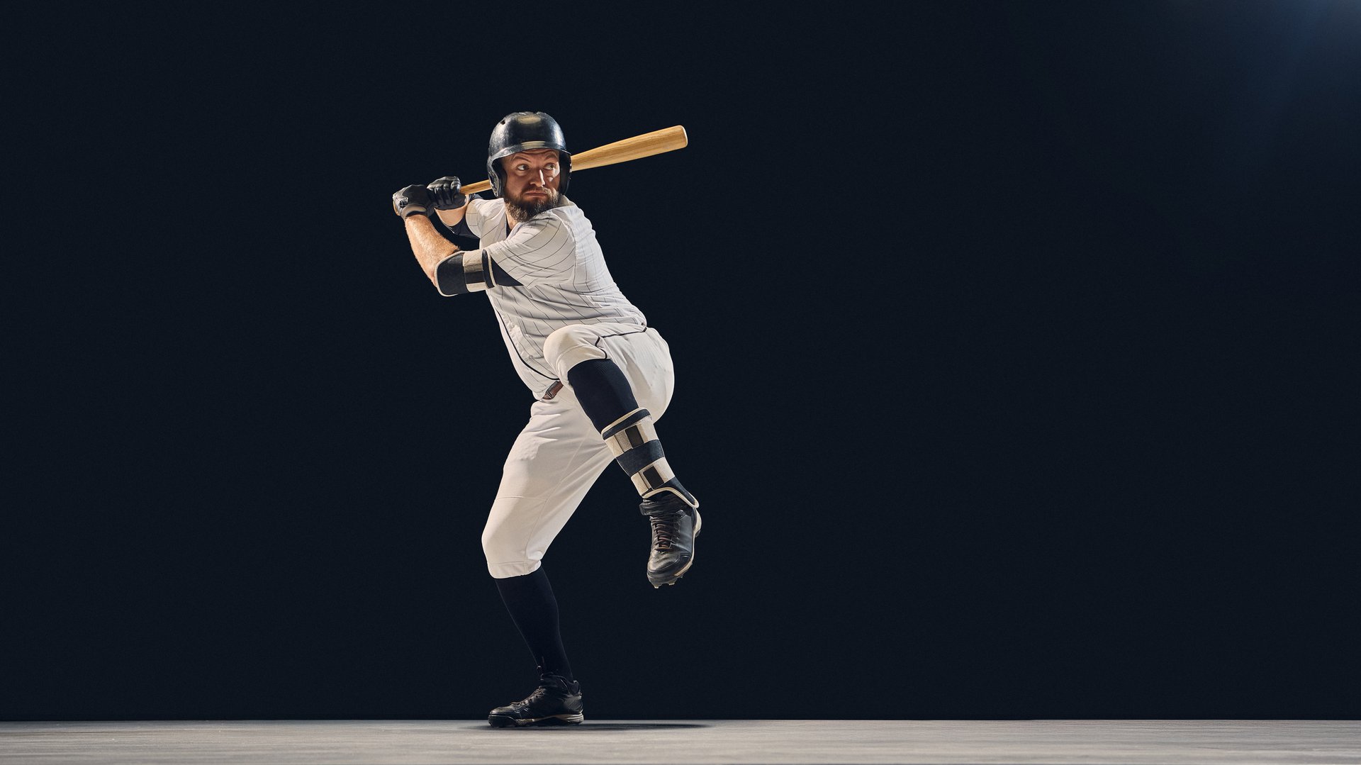 Baseball batter in pre-swing stance illustrating balance and body mechanics. Concept of motion readiness and posture analysis for sports education, athletic instruction, and uniform advertising.