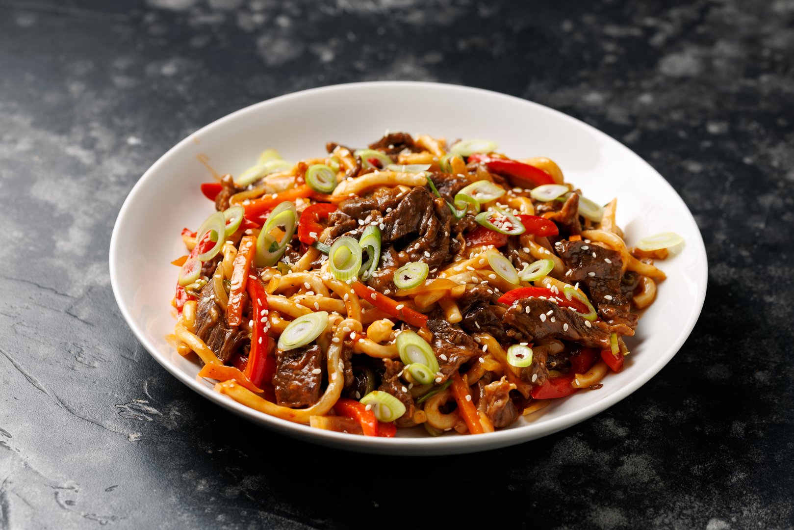Stir fry udon noodles with beef and vegetable. asian style food.