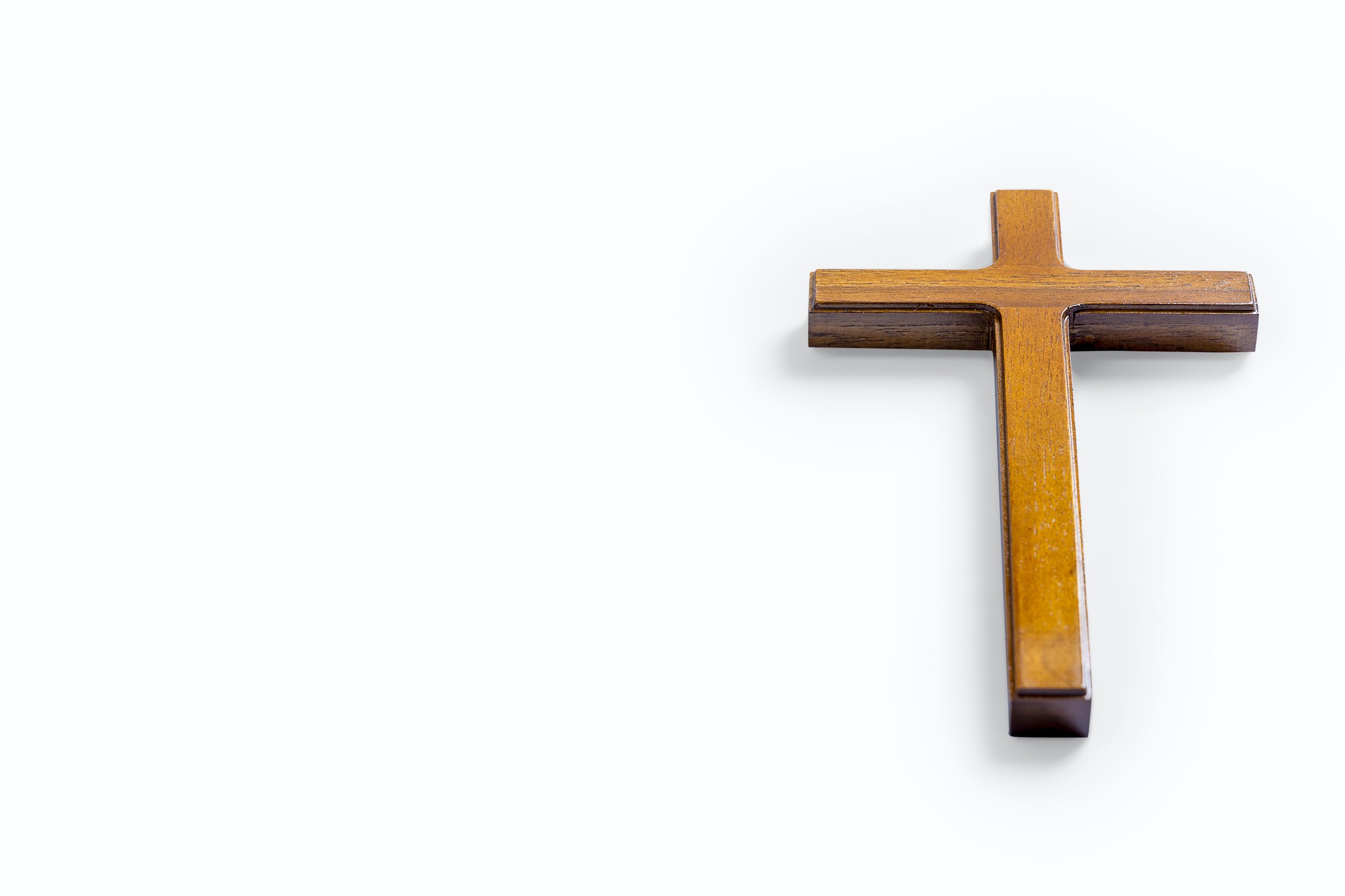 Wooden religion cross isolated over white background. Religious christian holiday. Symbol of faith in God, Christianity Feast, Easter, Good Friday, Palm Sunday. Religious christian concept