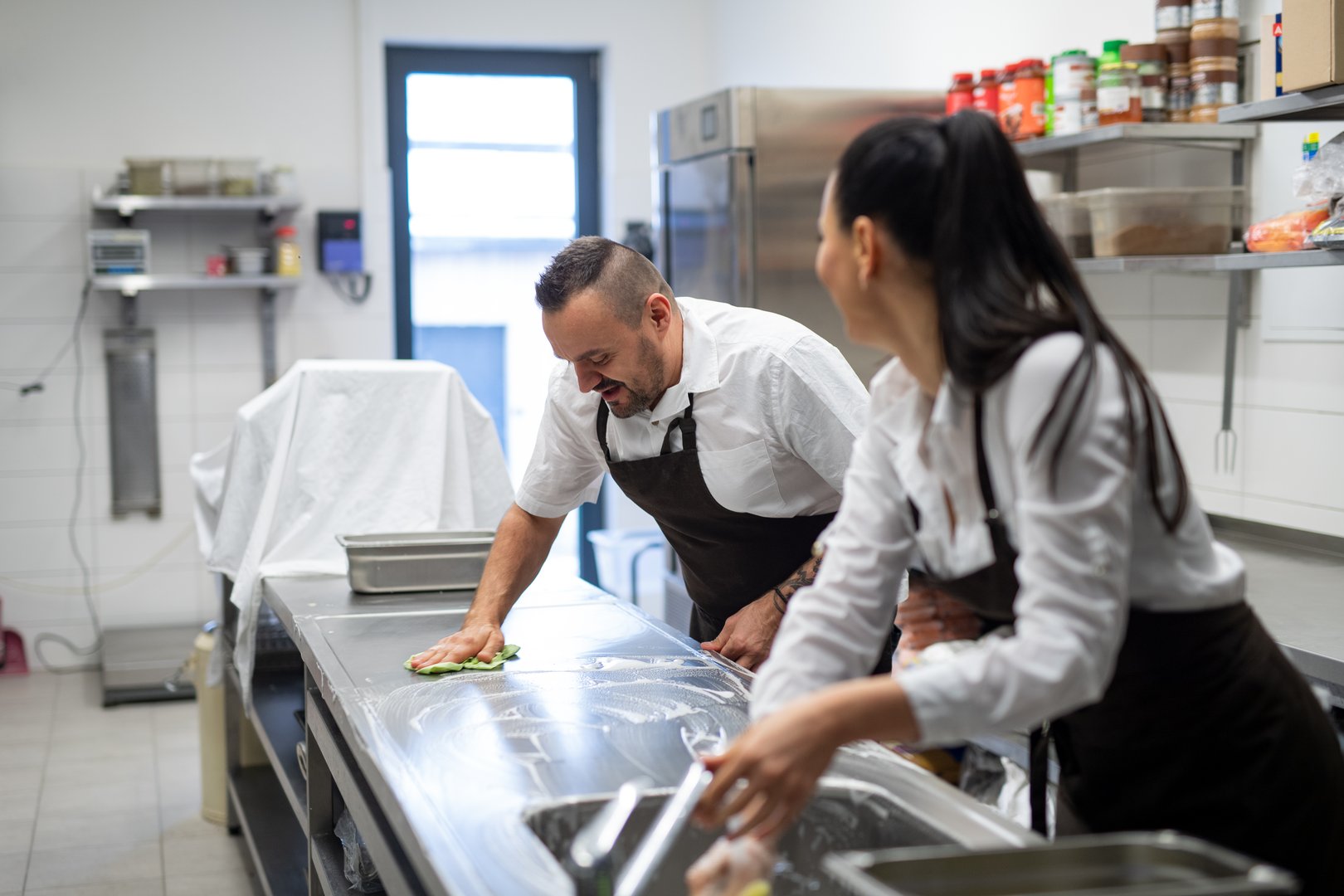 Professional kitchen cleaning team at work