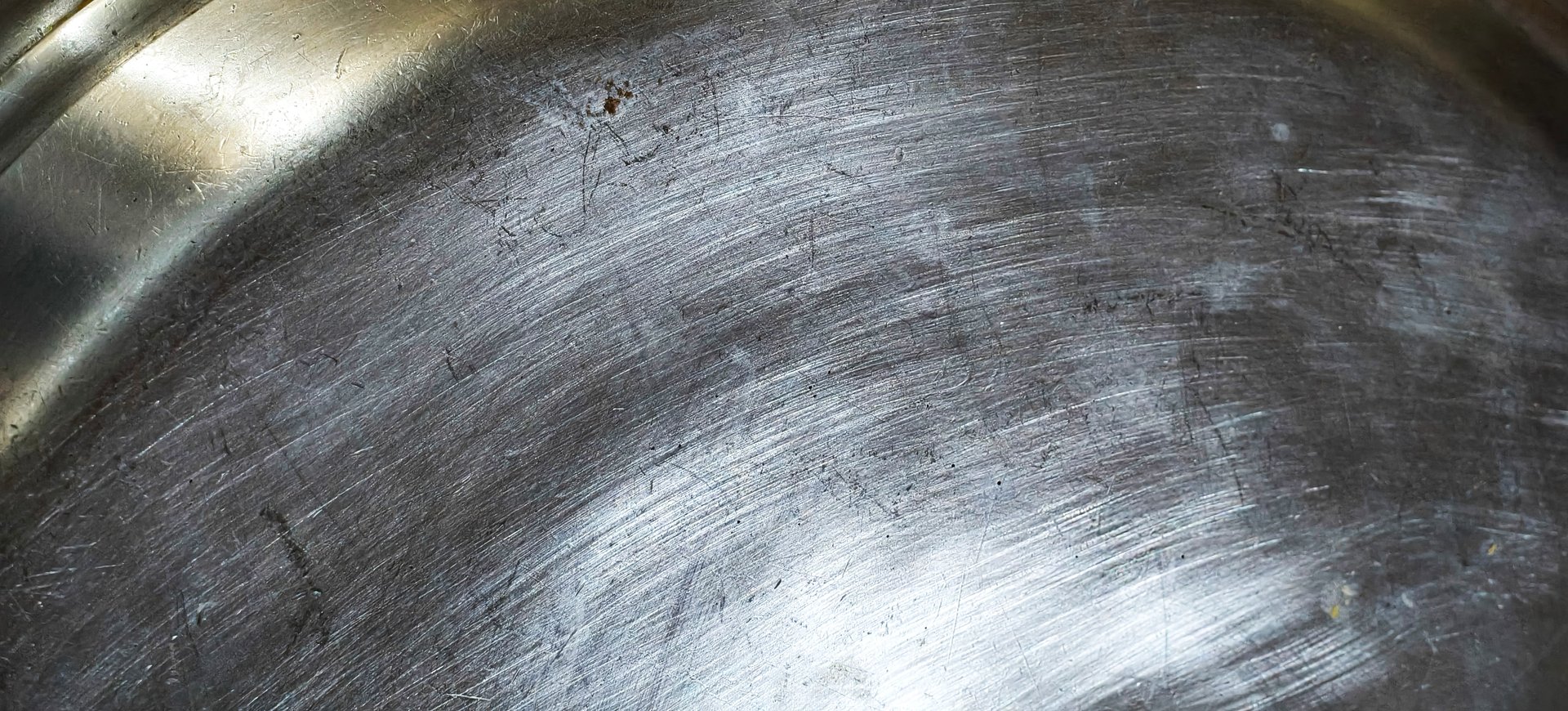 Silver engine part is being painted carefully on a clean, prepared workbench.