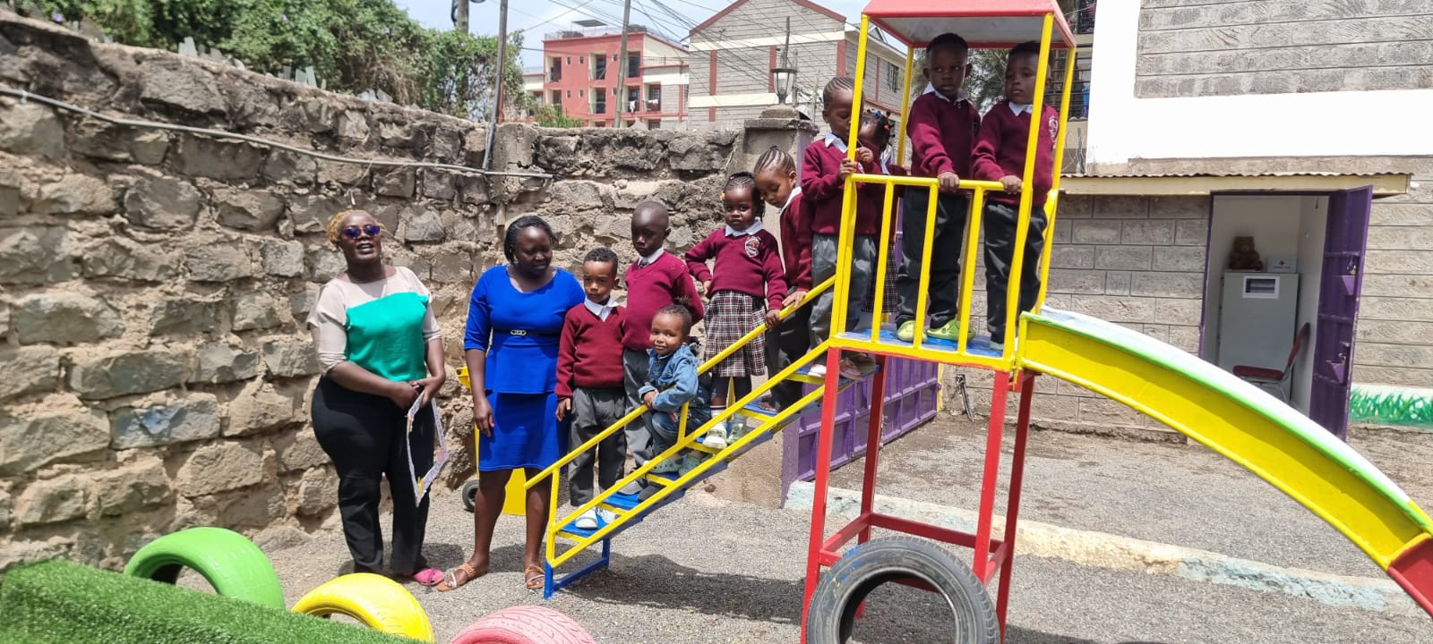 Outdoor play at Kindernest - children on slide