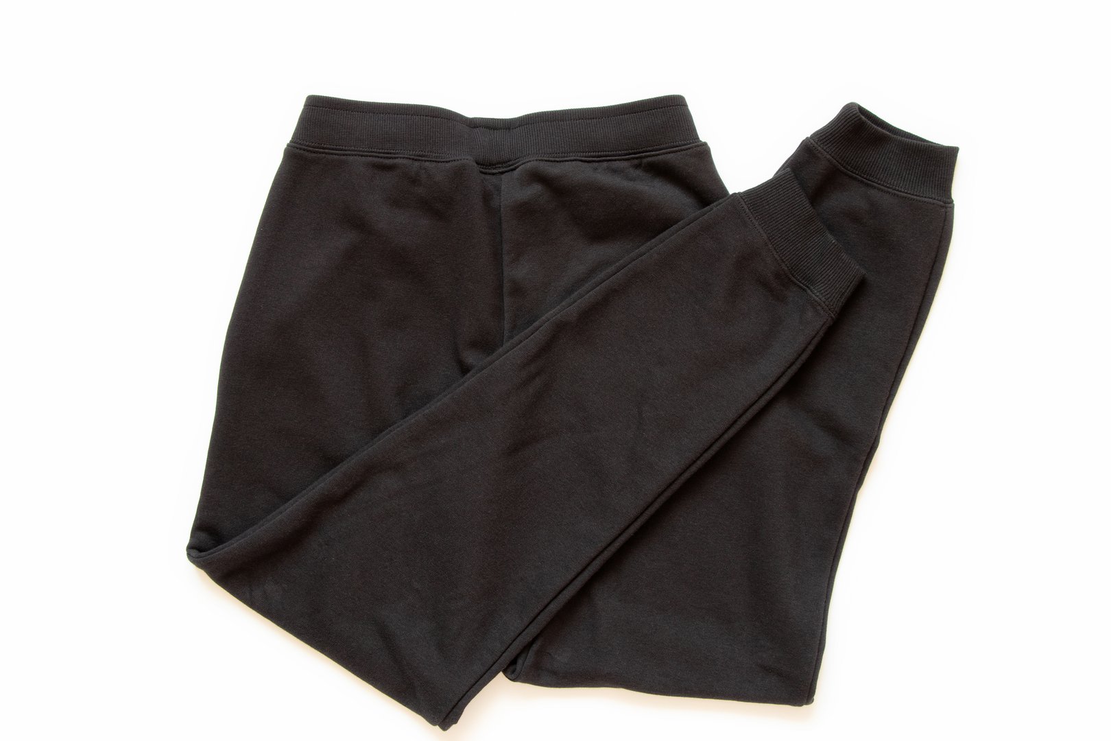 Black cotton sports pants close-up on white background