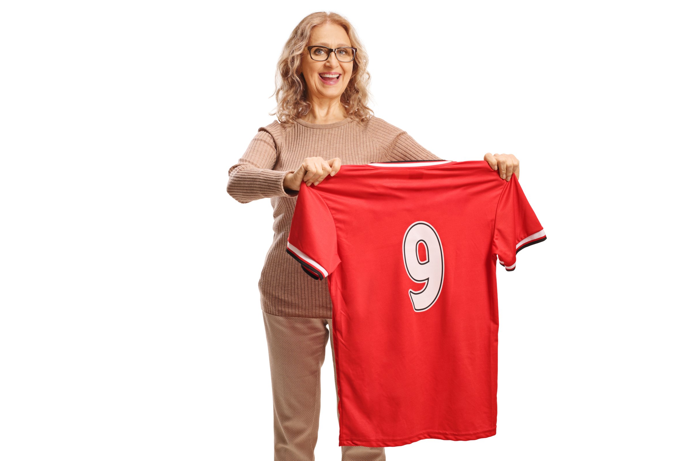 Happy mature woman holding a red football jersey with the number nine isolated on white background