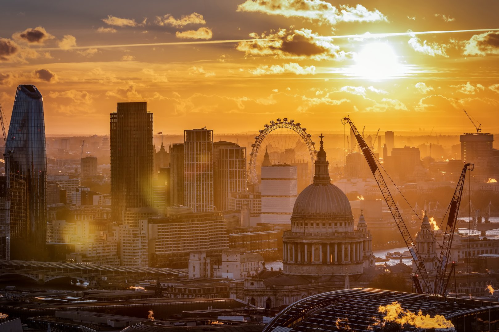 Elevated sunset view of the London skyline with St. Pauls Cathedral and Thames River
