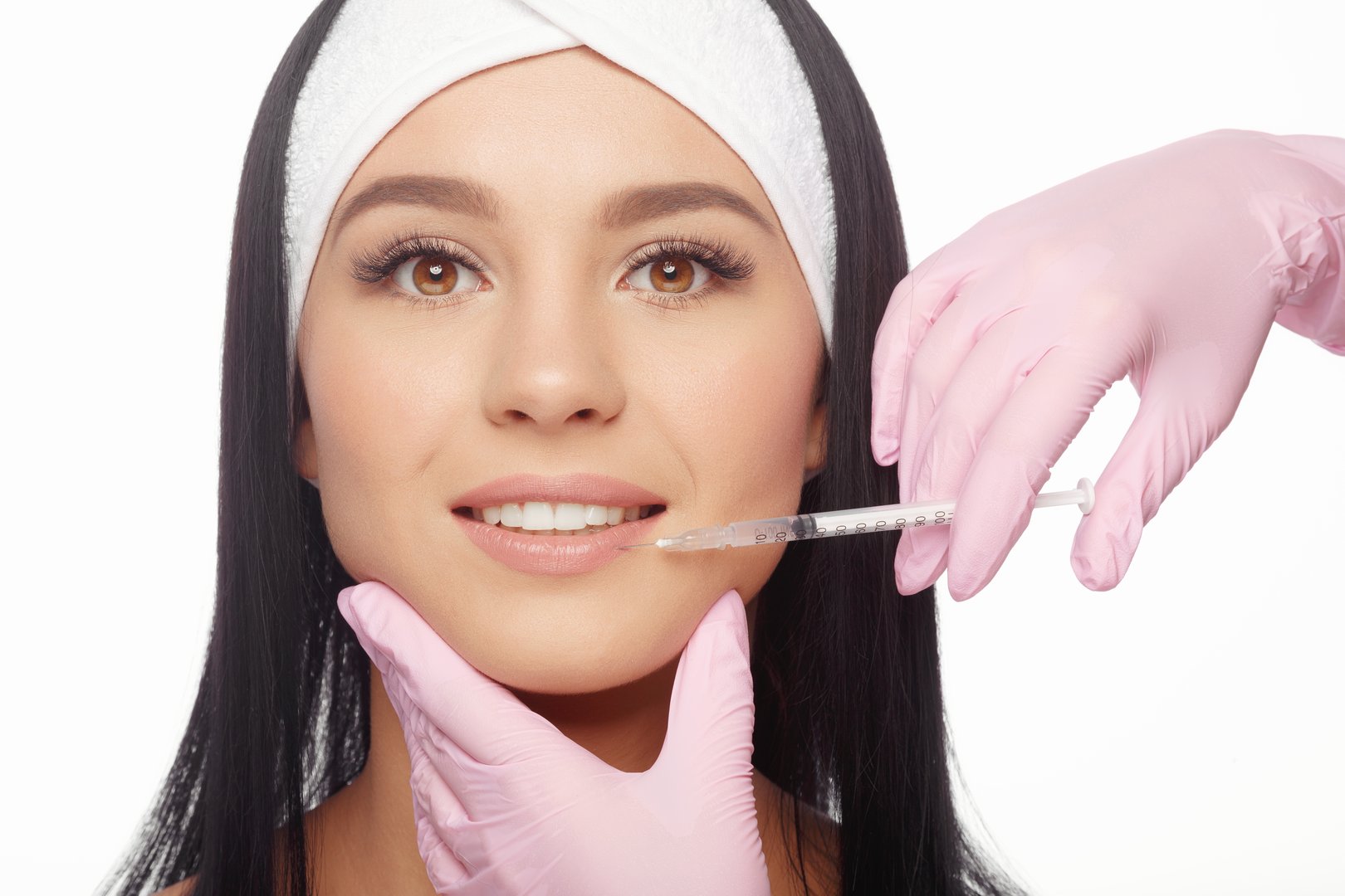 Young woman gets a botox injection in her lips. Close-up woman hyaluronic acid injection in lips. Injections of skin rejuvenation. Cosmetic procedures, injections, botox and hyaluronic acid.