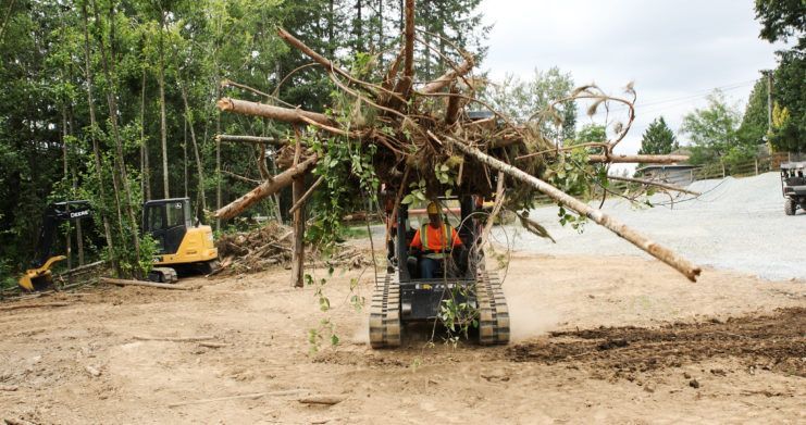 Kubota SVL75 with Quick Claw Rake attachment