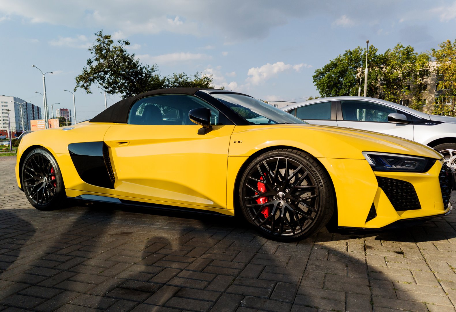 Minsk, Belarus, August 30, 2024 - Side view modern supercar Audi R8 V10 parked in city streets