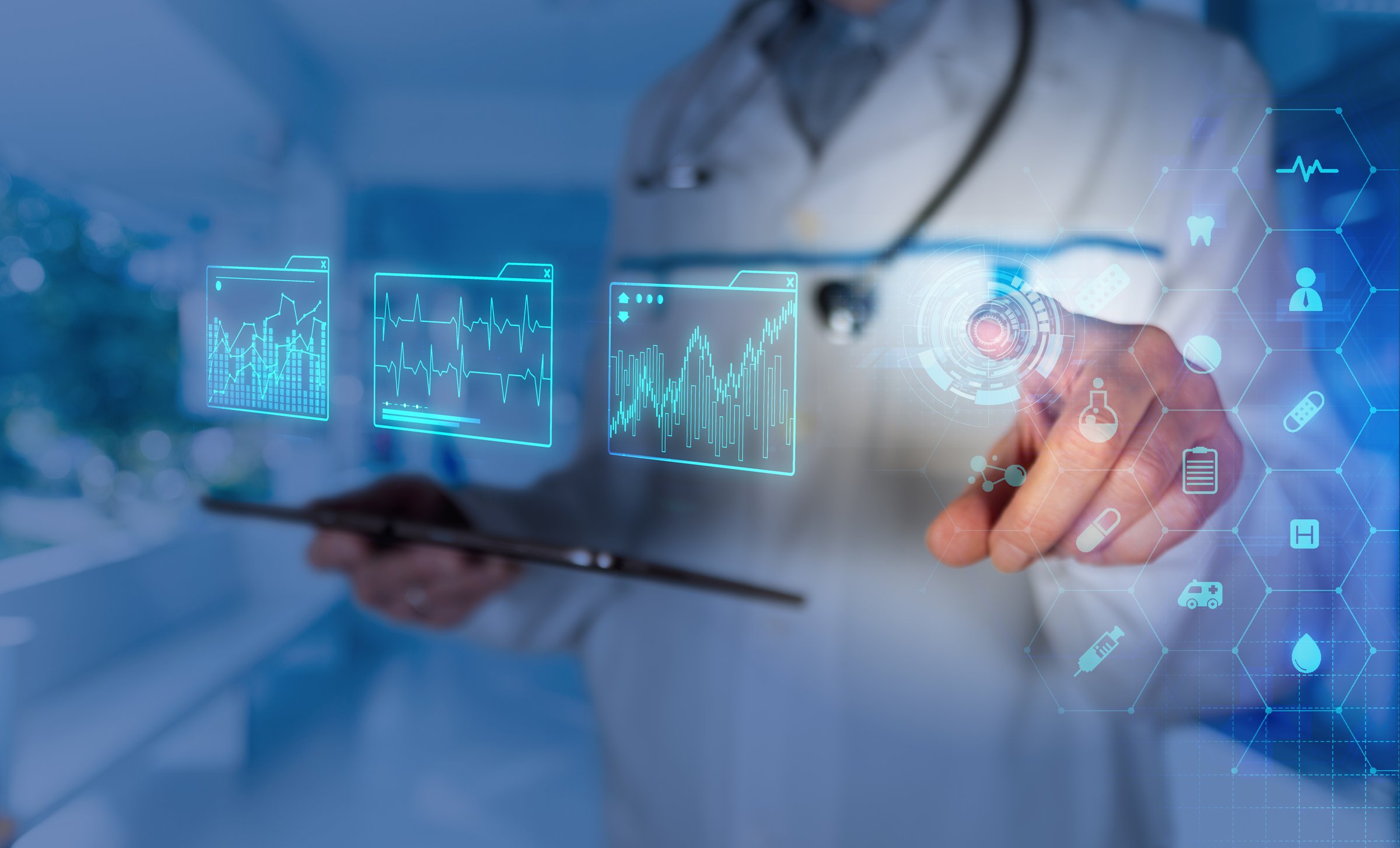 A healthcare professional is engaged in reviewing digital health records using a tablet while analyzing data in a clinical environment.