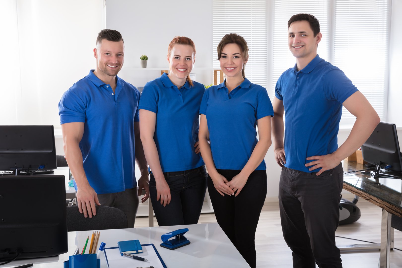 Portrait Of A Smiling Janitors In Uniform At Office