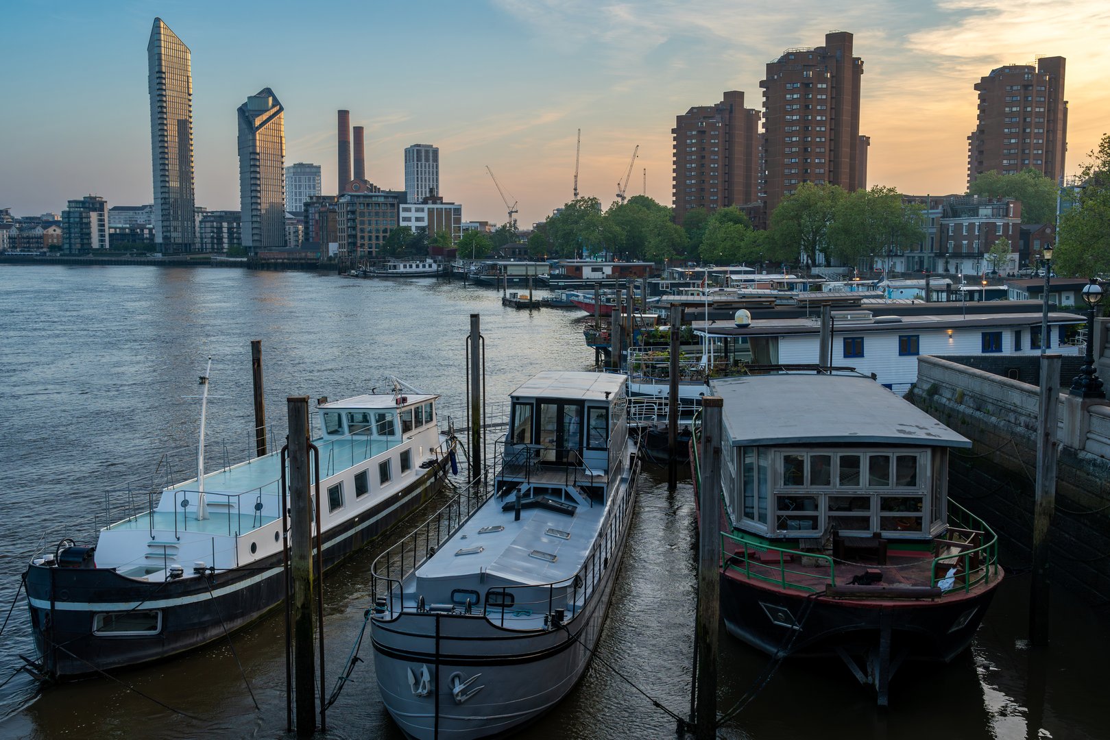 Cityscape of London, modern high-rise buildings nearby Chelsea Harbour seen from the Battersea Bridge at dusk