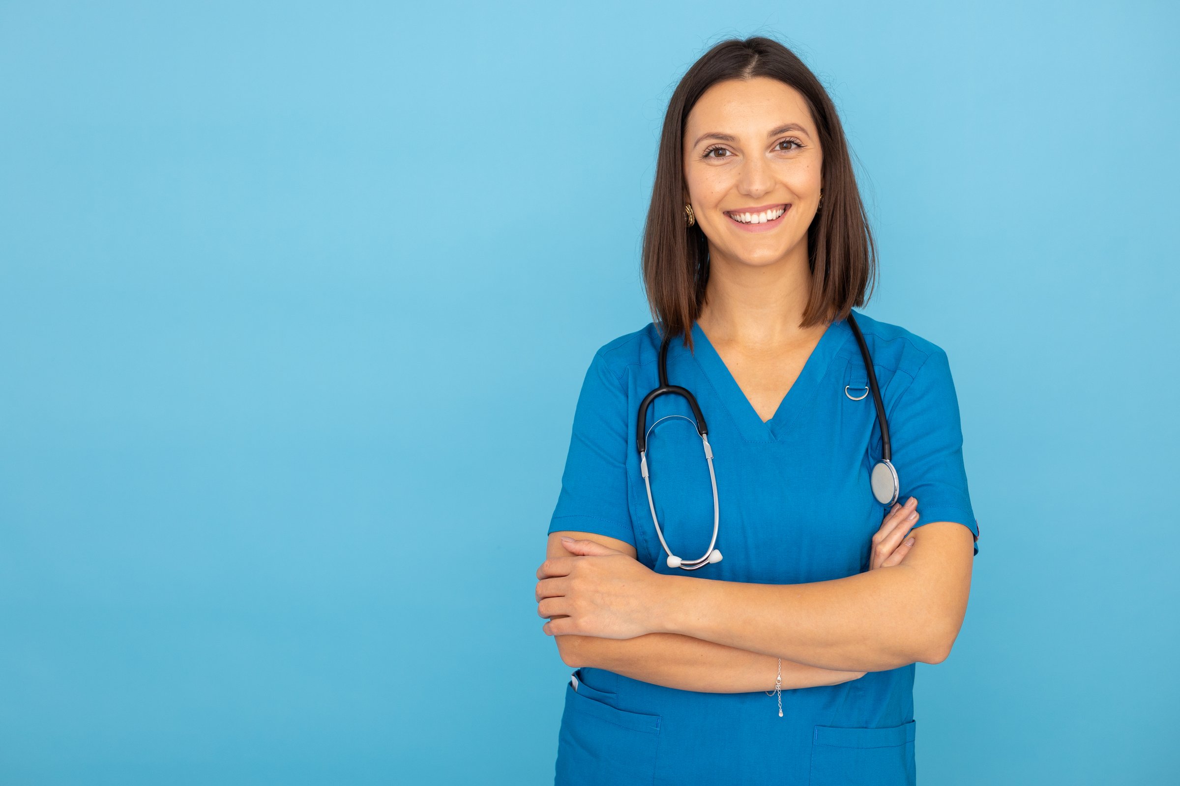 Portrait of dedicated young nurse in scrub uniform