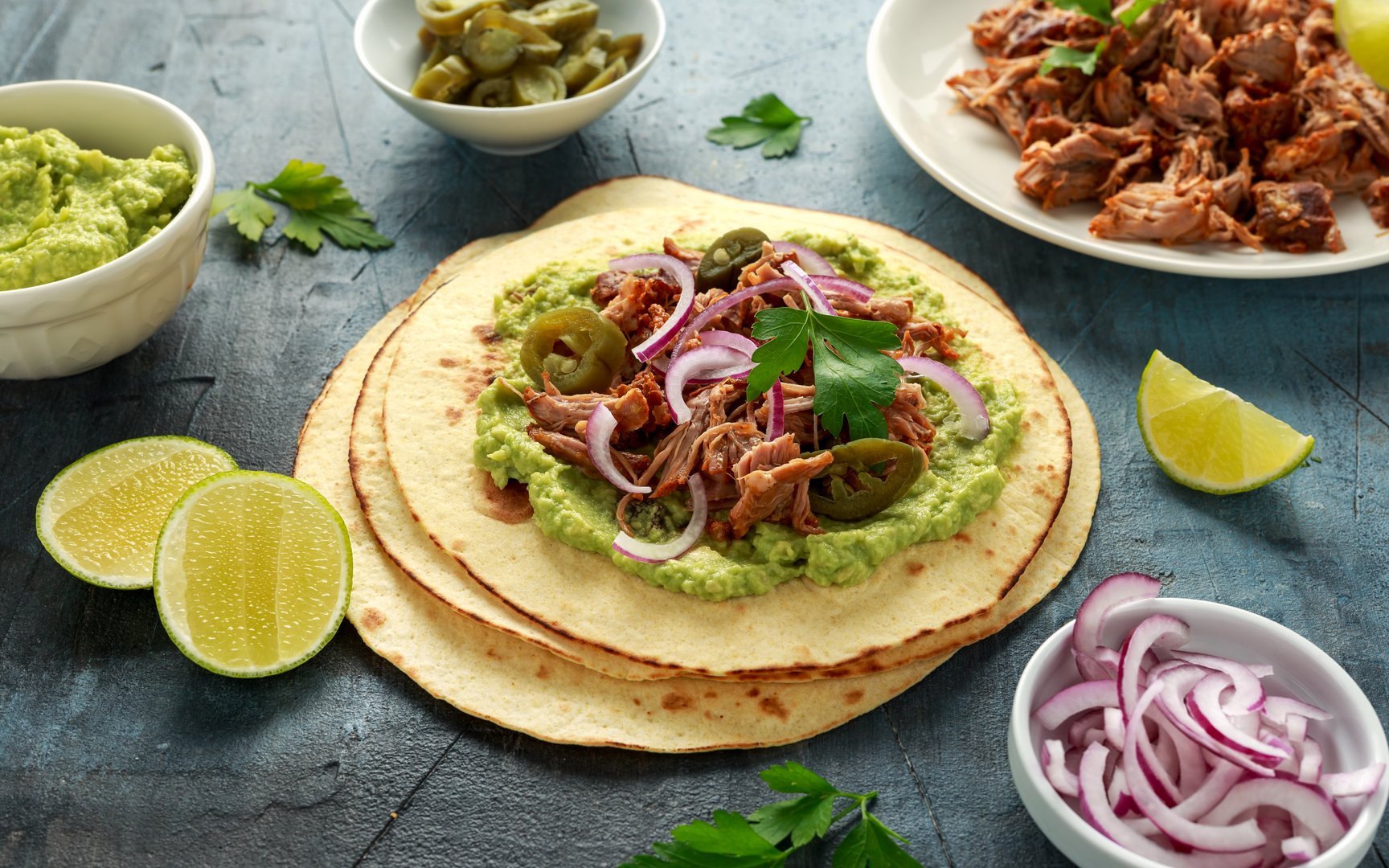 Mexican Corn tortilla with shredded Pork, avocado, red onion and jalapeno.