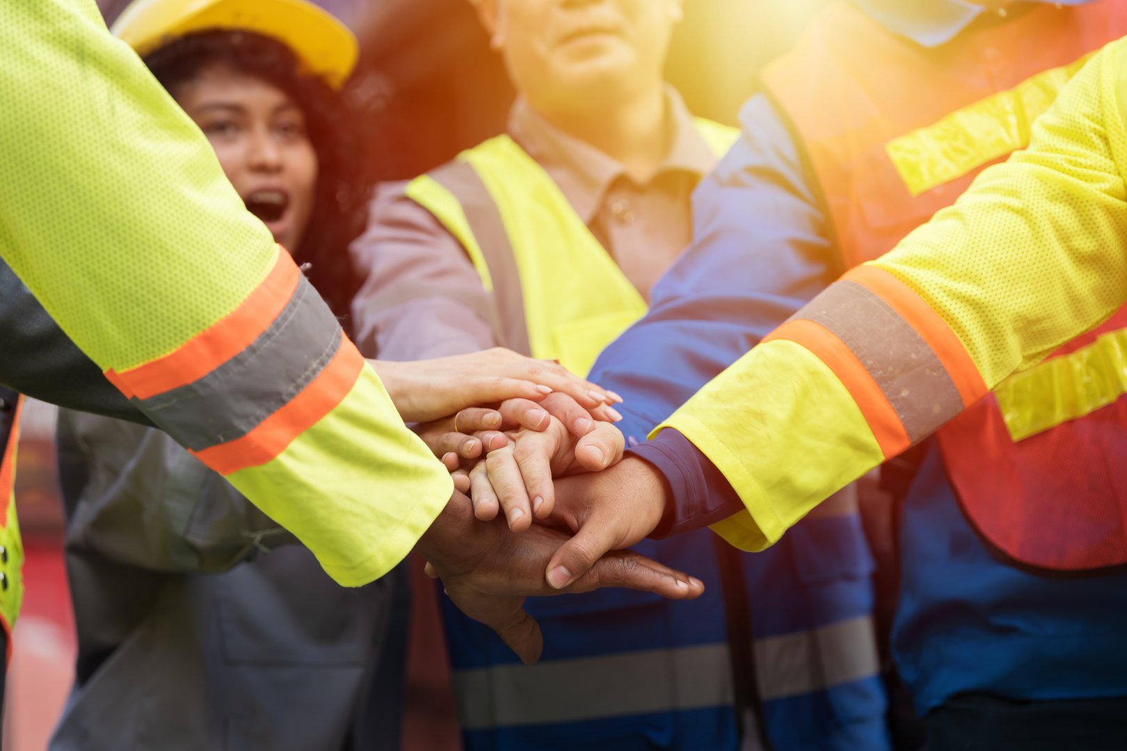Join hands together, Unity and teamwork concept. Group of male and female workers standing putting their hands together. Completed finish job. Successful of work