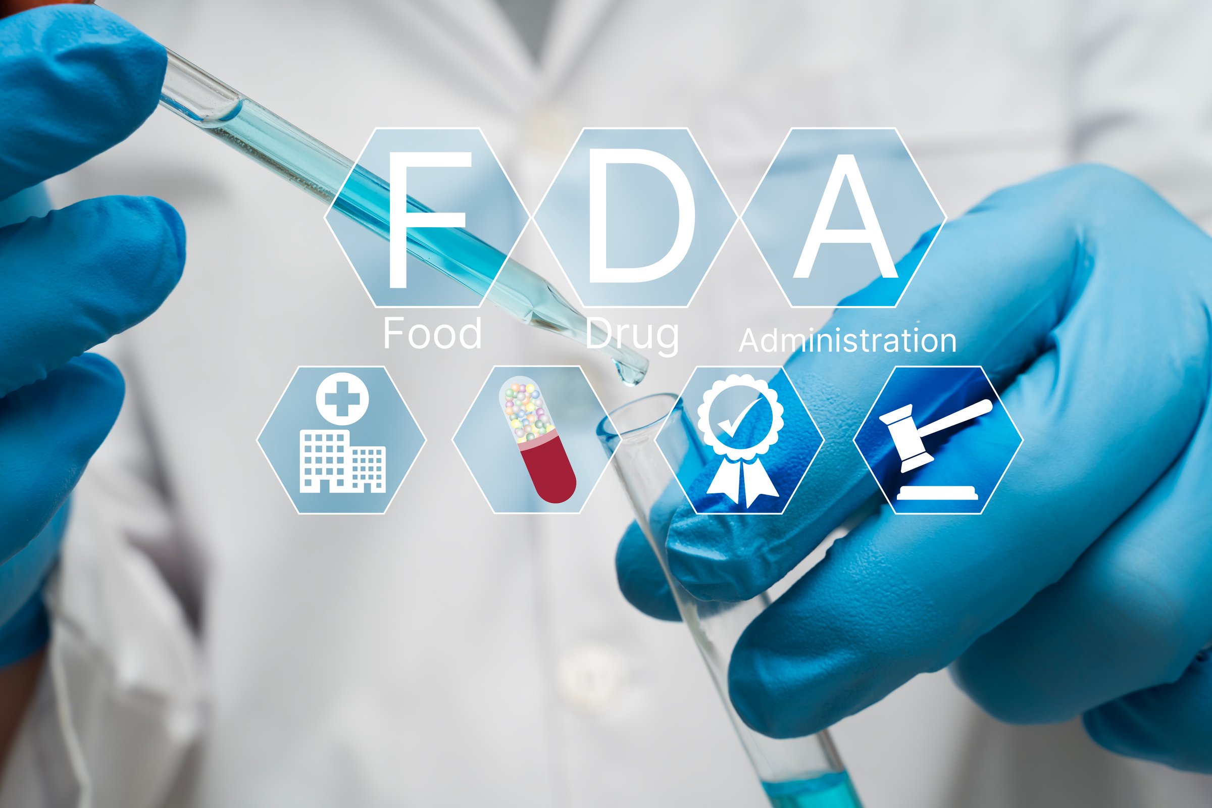 Close up of scientist with blue gloves using pipette and test tube in laboratory with FDA approval icons, representing food and drug administration, safety standards, clinical testing, and regulation.