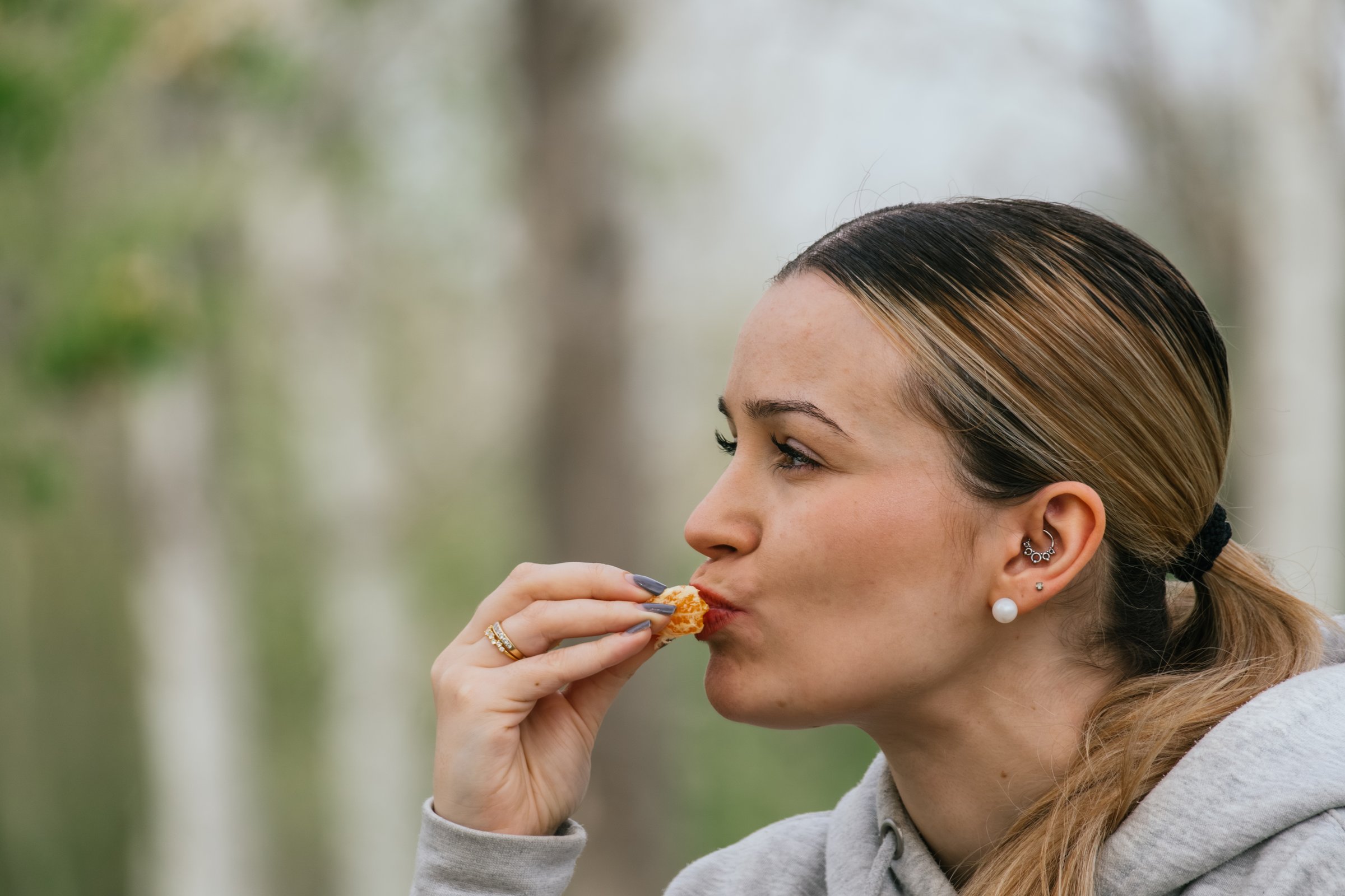 Woman eating fruit during a break on a hiking route