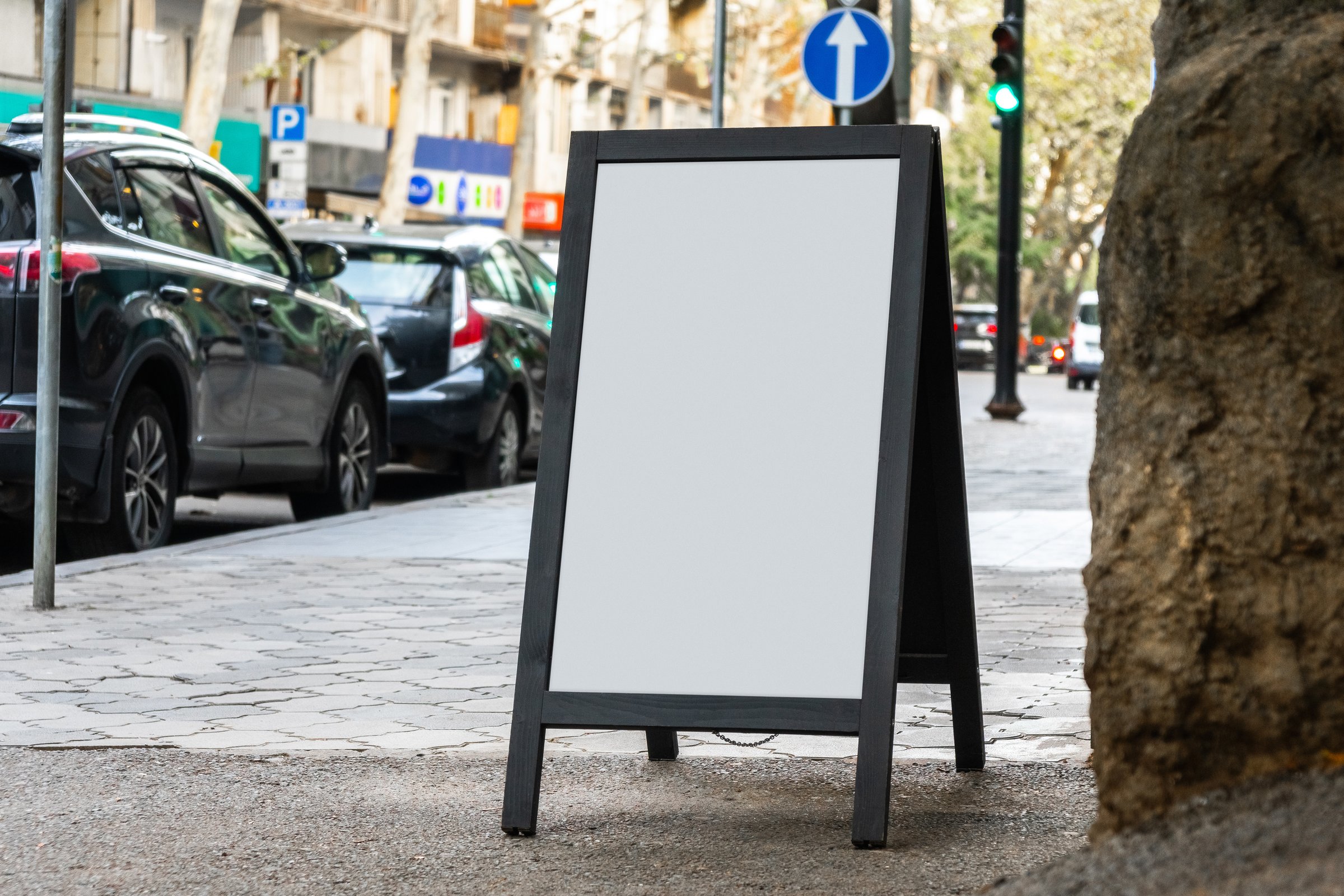 Blank white sandwich board on a street. Portable folding billboard