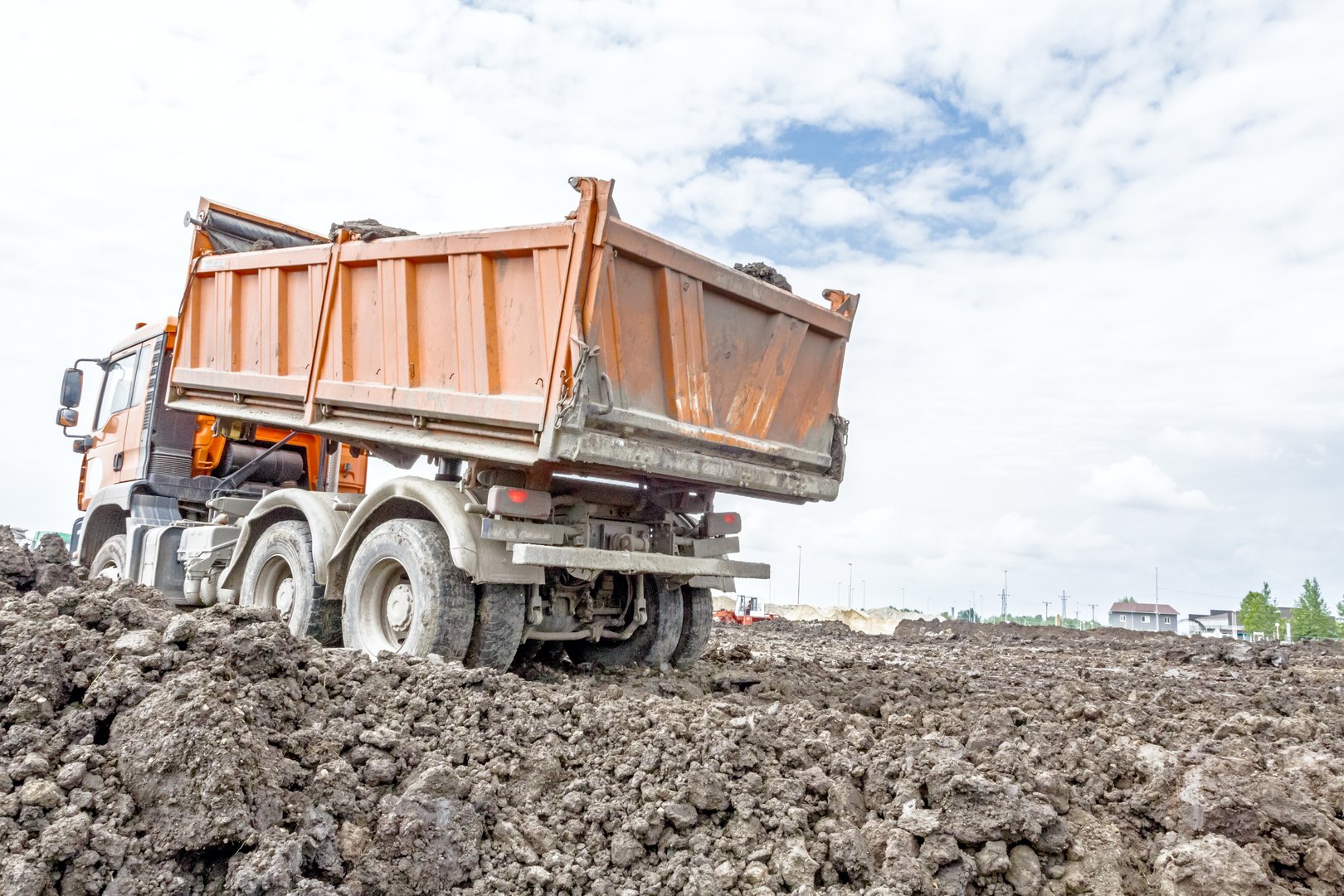 Big hydraulic dump truck is moving into reverse, prepare to unload cargo.