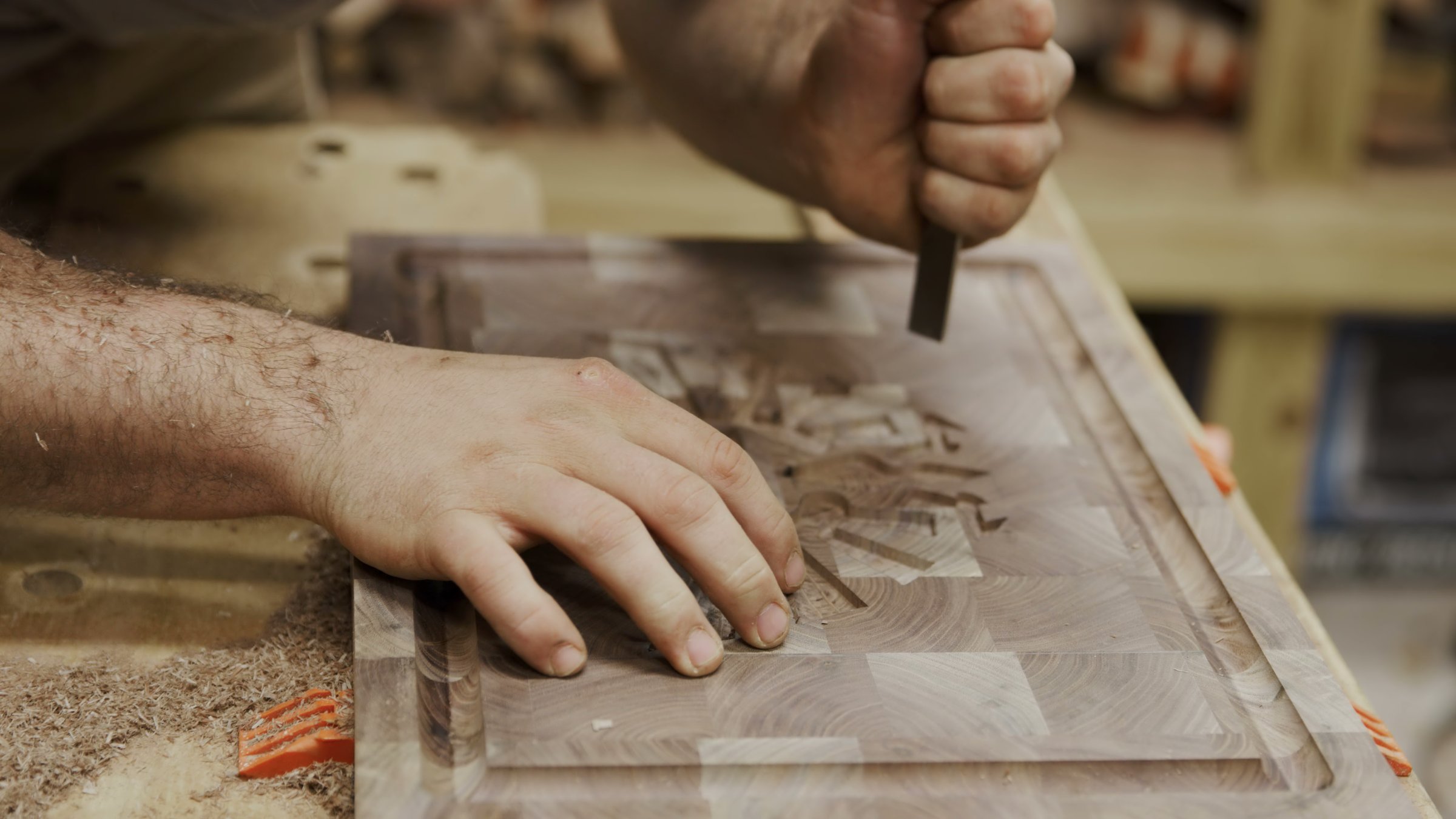 Craftsman skillfully uses a chisel to shape a beautiful wooden board in High Point, North Carolina, United States