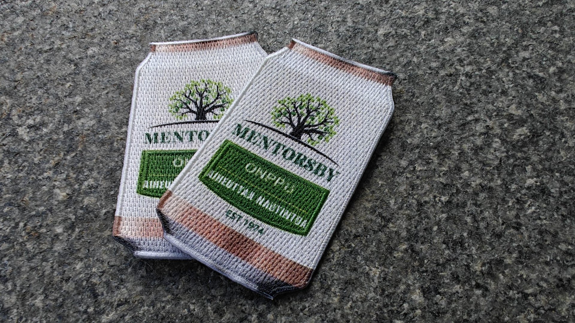 Two embroidered patches shaped like beverage cans with a tree logo and the words MNTNSKY and Camper IPA.