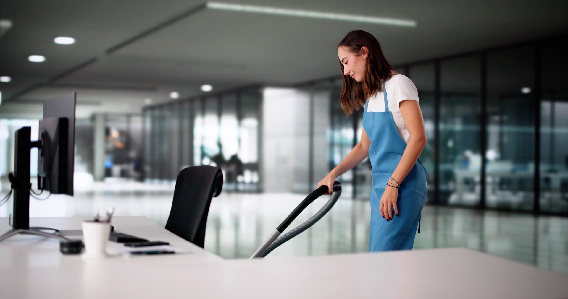 Professional Cleaner: Woman Maintains Sparkling Workspace For Productive Office Environment